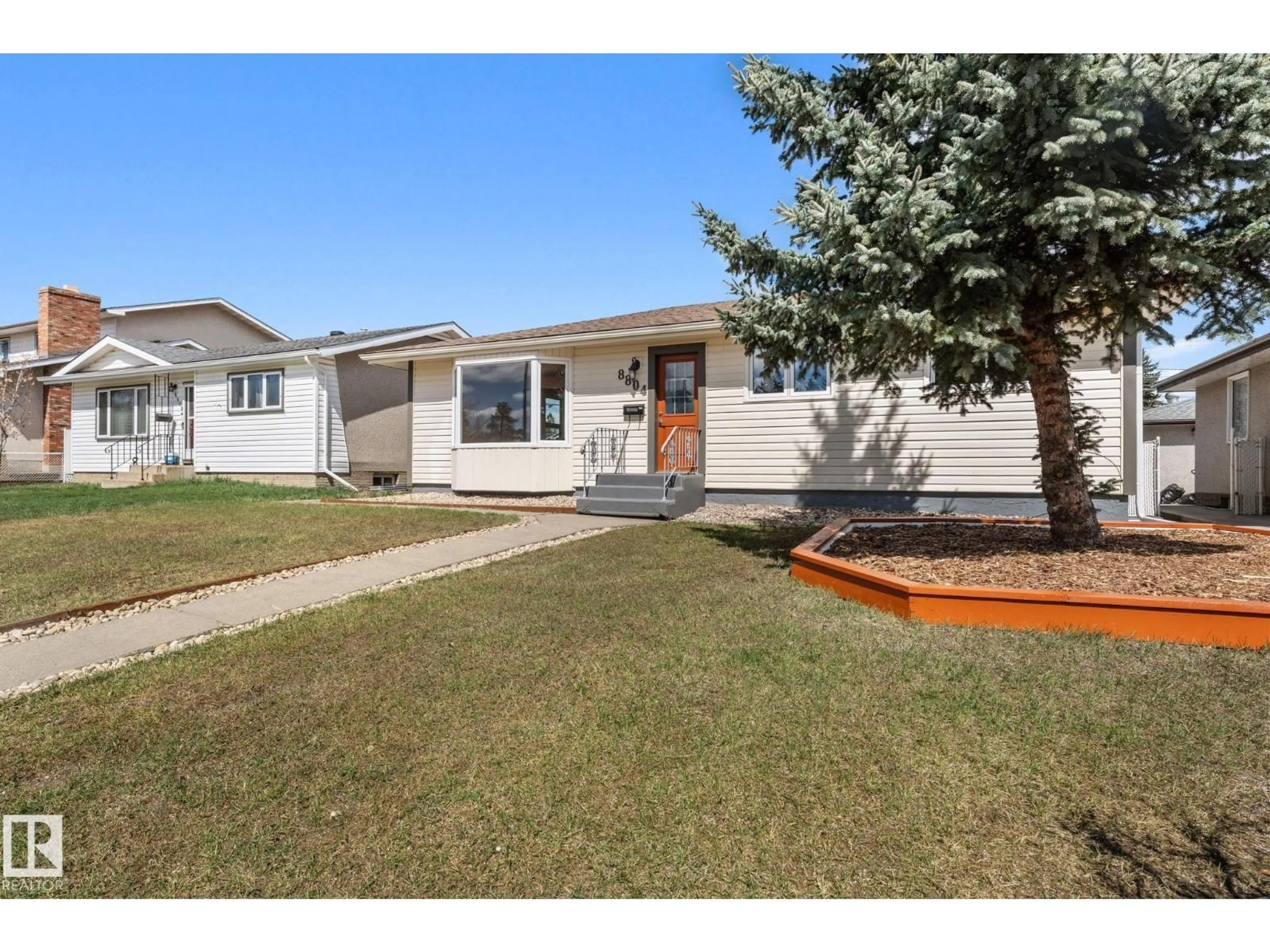 Home with vinyl exterior material, street for 8804 135 AV, Edmonton Alberta T5E1N3