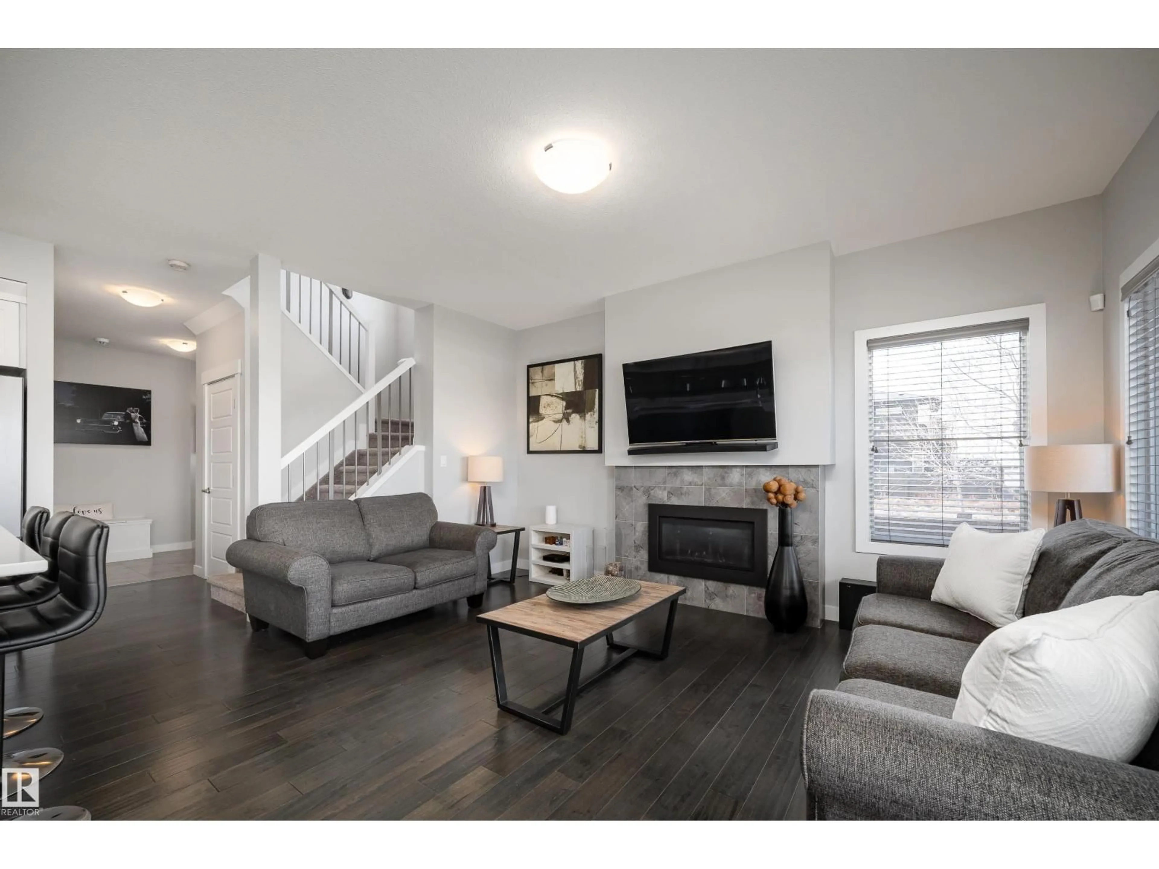 Living room with furniture, wood/laminate floor for 2704 KOSHAL PL, Edmonton Alberta T6W3J7