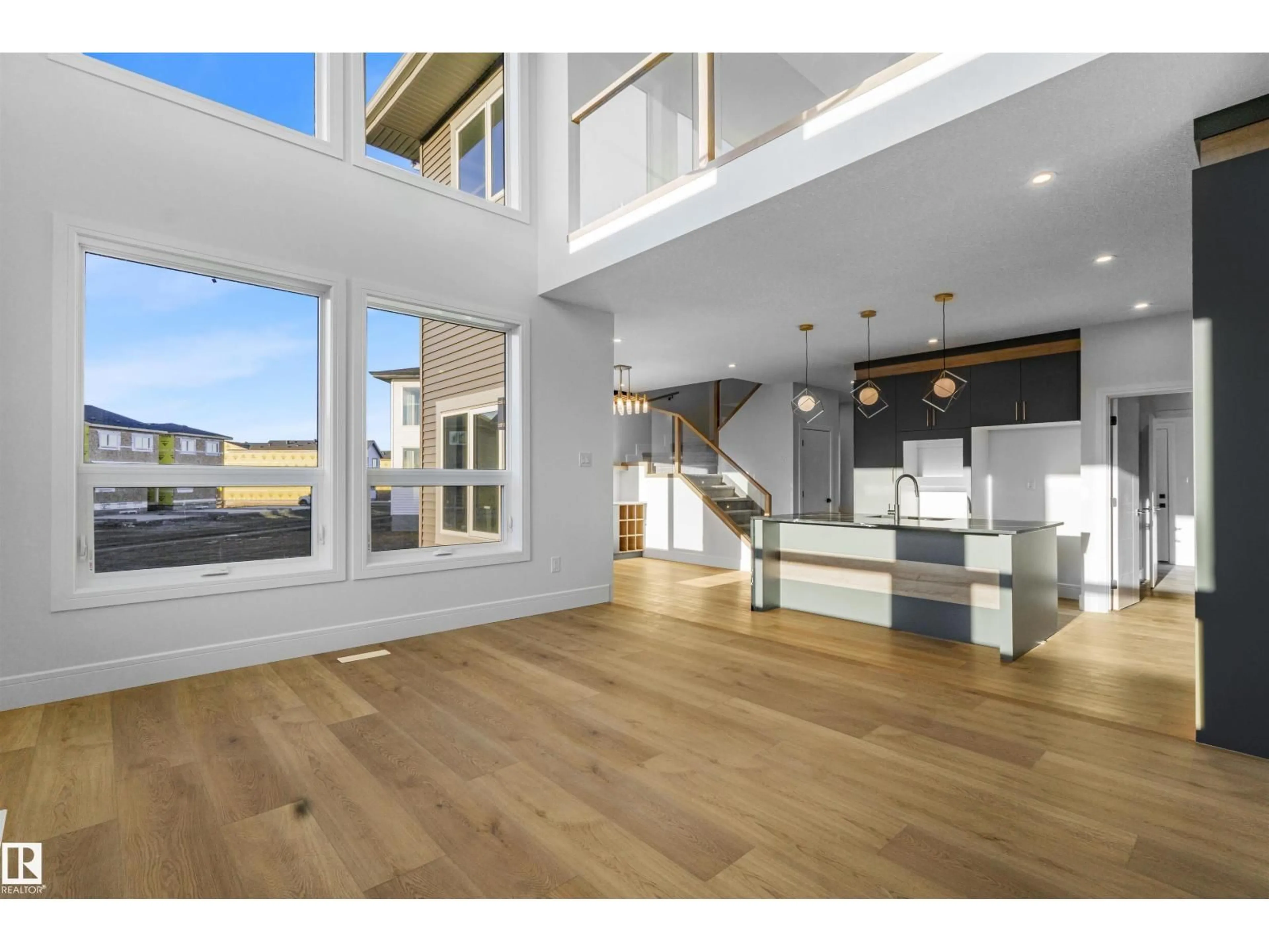 Open concept kitchen, wood/laminate floor for 1604 64 AVE NE, Rural Leduc County Alberta T4X2C1