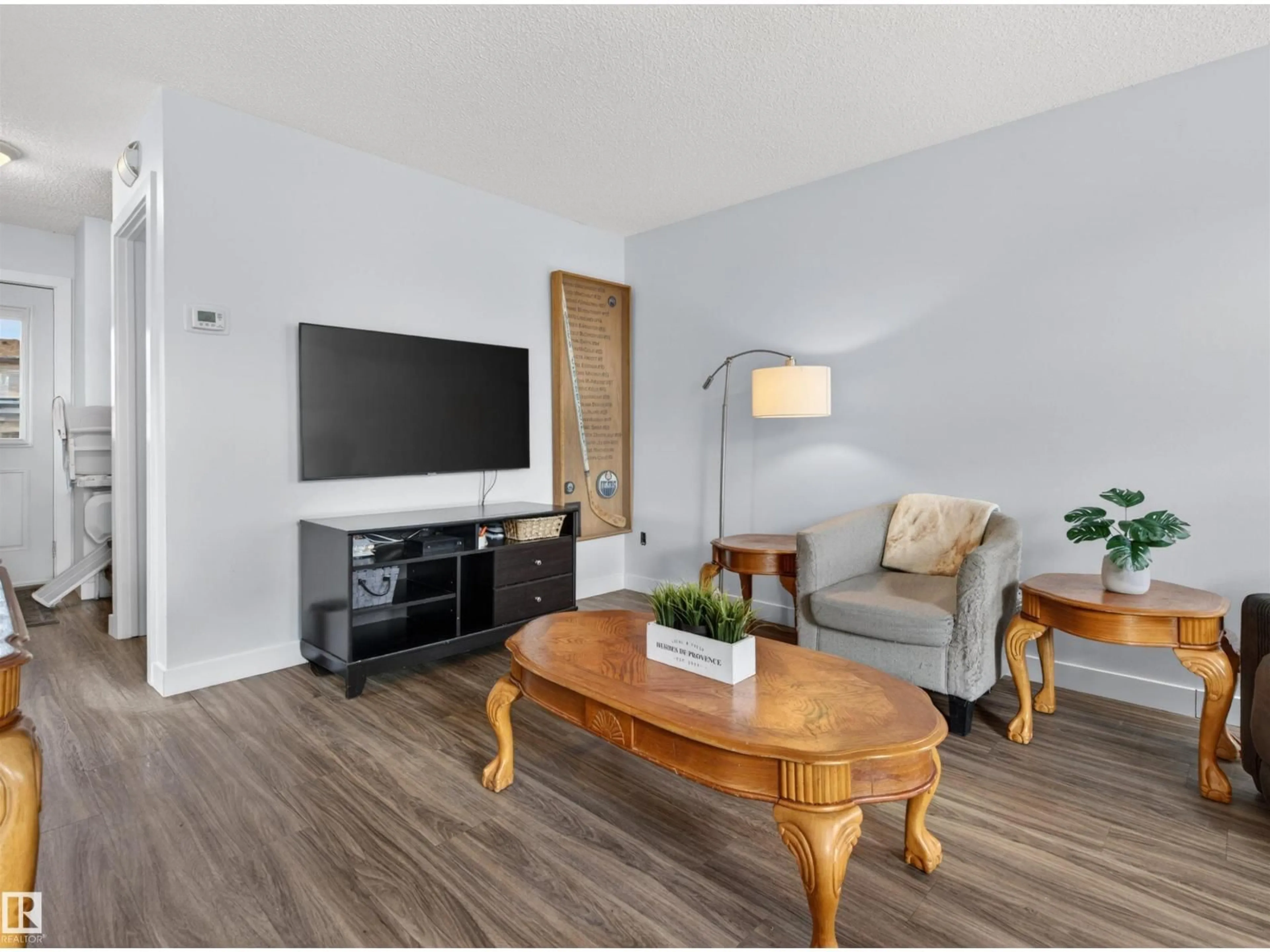 Living room with furniture, wood/laminate floor for 205 13831 24 ST NW, Edmonton Alberta T5Y1K1