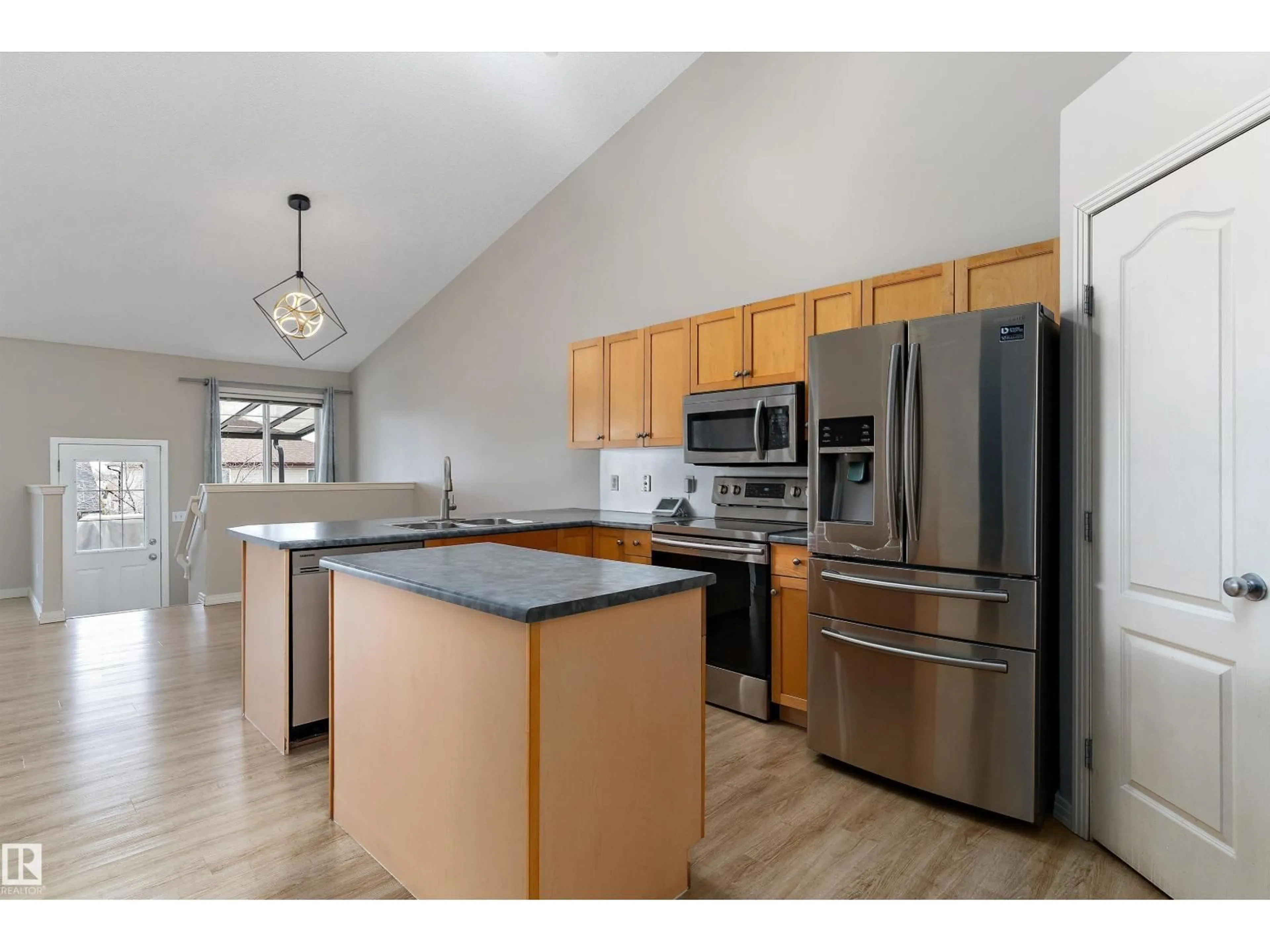 Open concept kitchen, wood/laminate floor for 15109 MILLER BV, Edmonton Alberta T5Y3A1