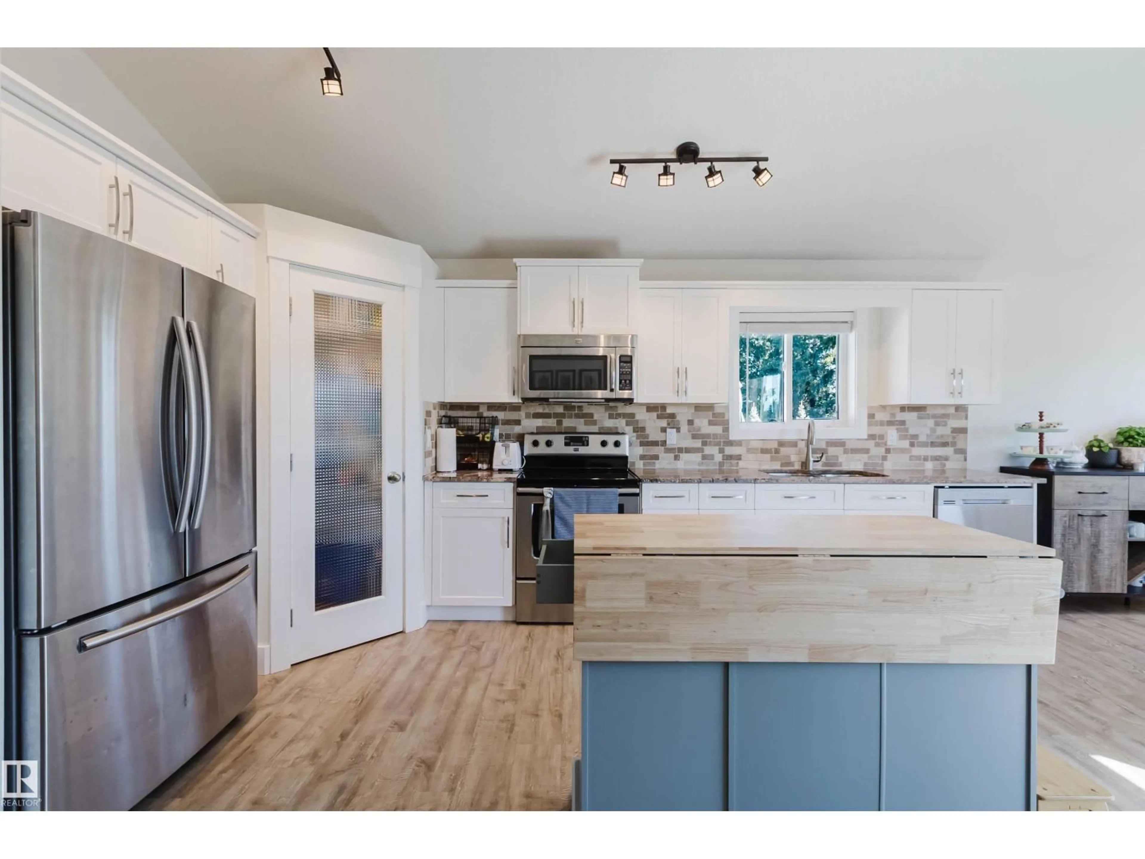 Open concept kitchen, wood/laminate floor for 5201 BON ACRES CR, Bon Accord Alberta T0A0K0