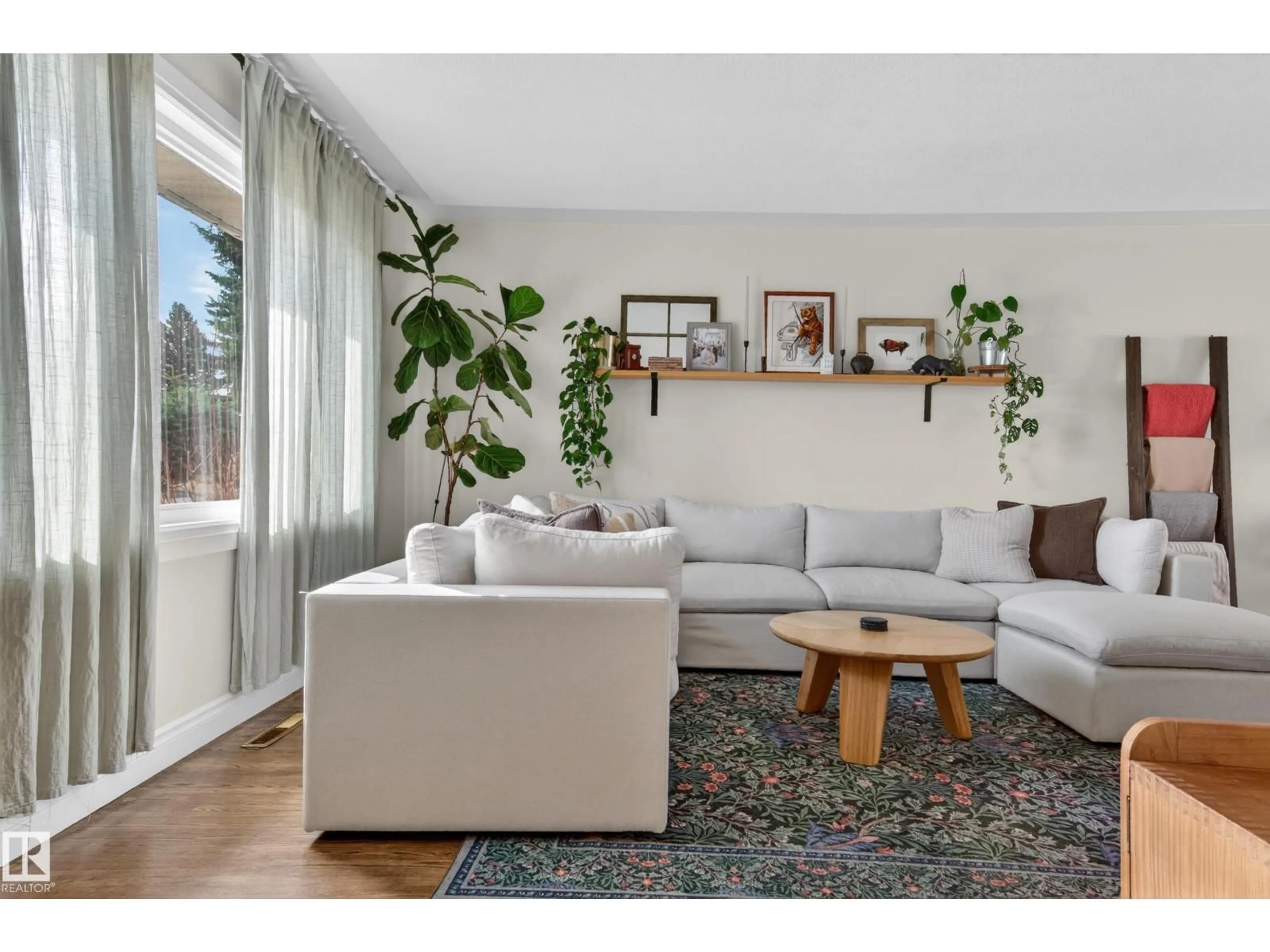 Living room with furniture, wood/laminate floor for 10740 44 ST, Edmonton Alberta T6A1W4