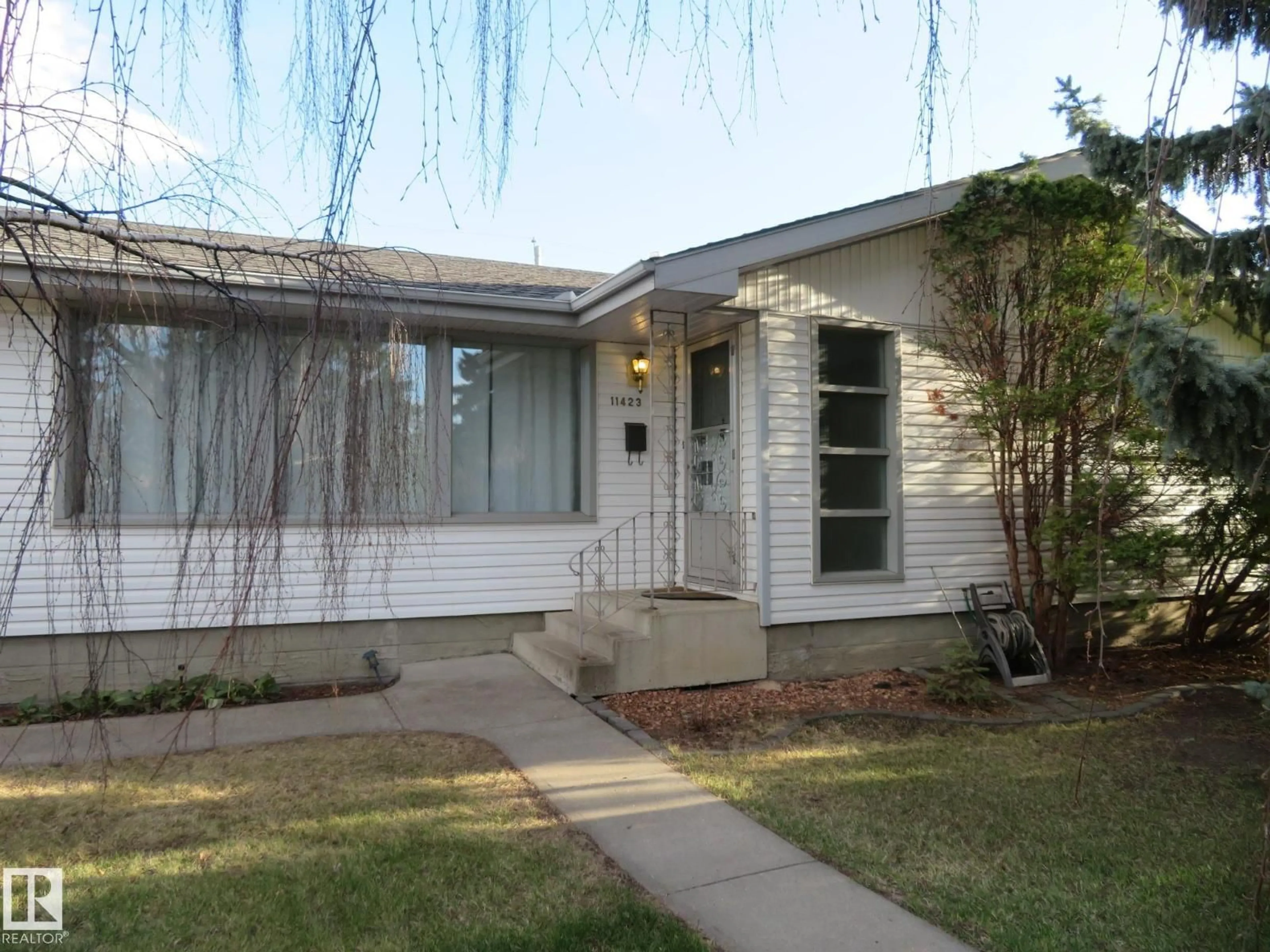 Home with vinyl exterior material, street for 11423 50 AV, Edmonton Alberta T6E2J4