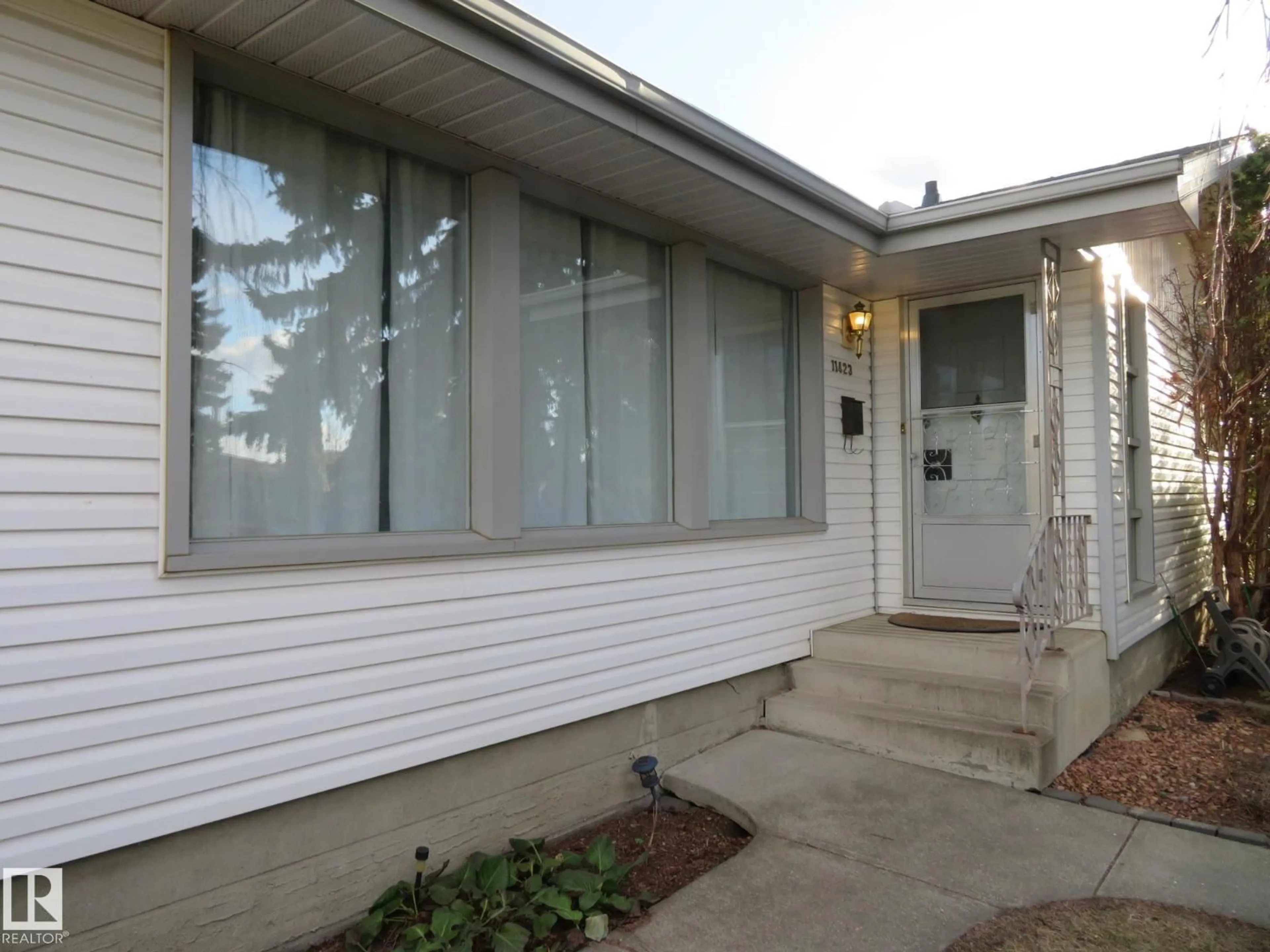 Home with vinyl exterior material, street for 11423 50 AV, Edmonton Alberta T6E2J4