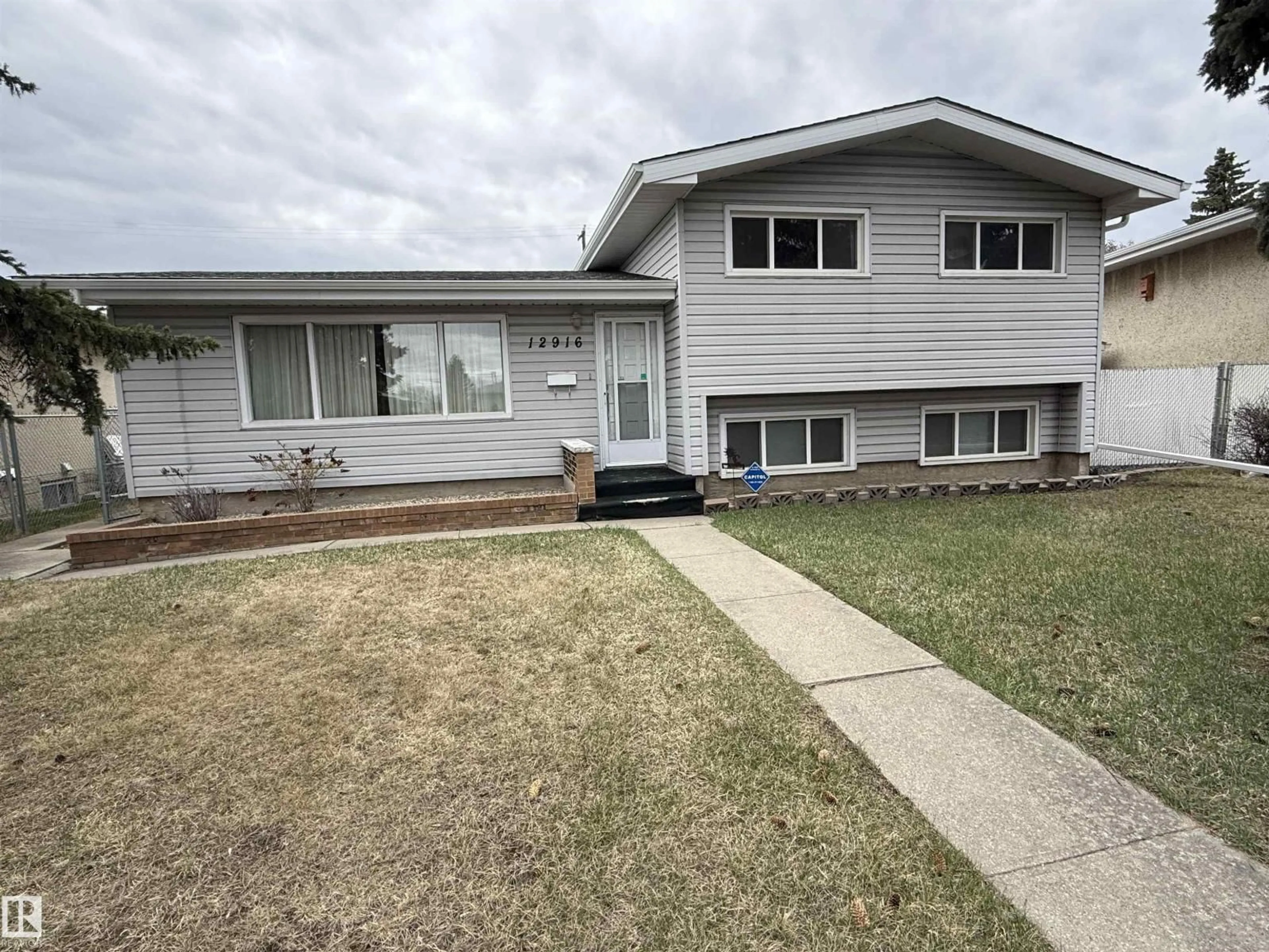 Home with vinyl exterior material, street for 12916 95A ST NW, Edmonton Alberta T5E4A1