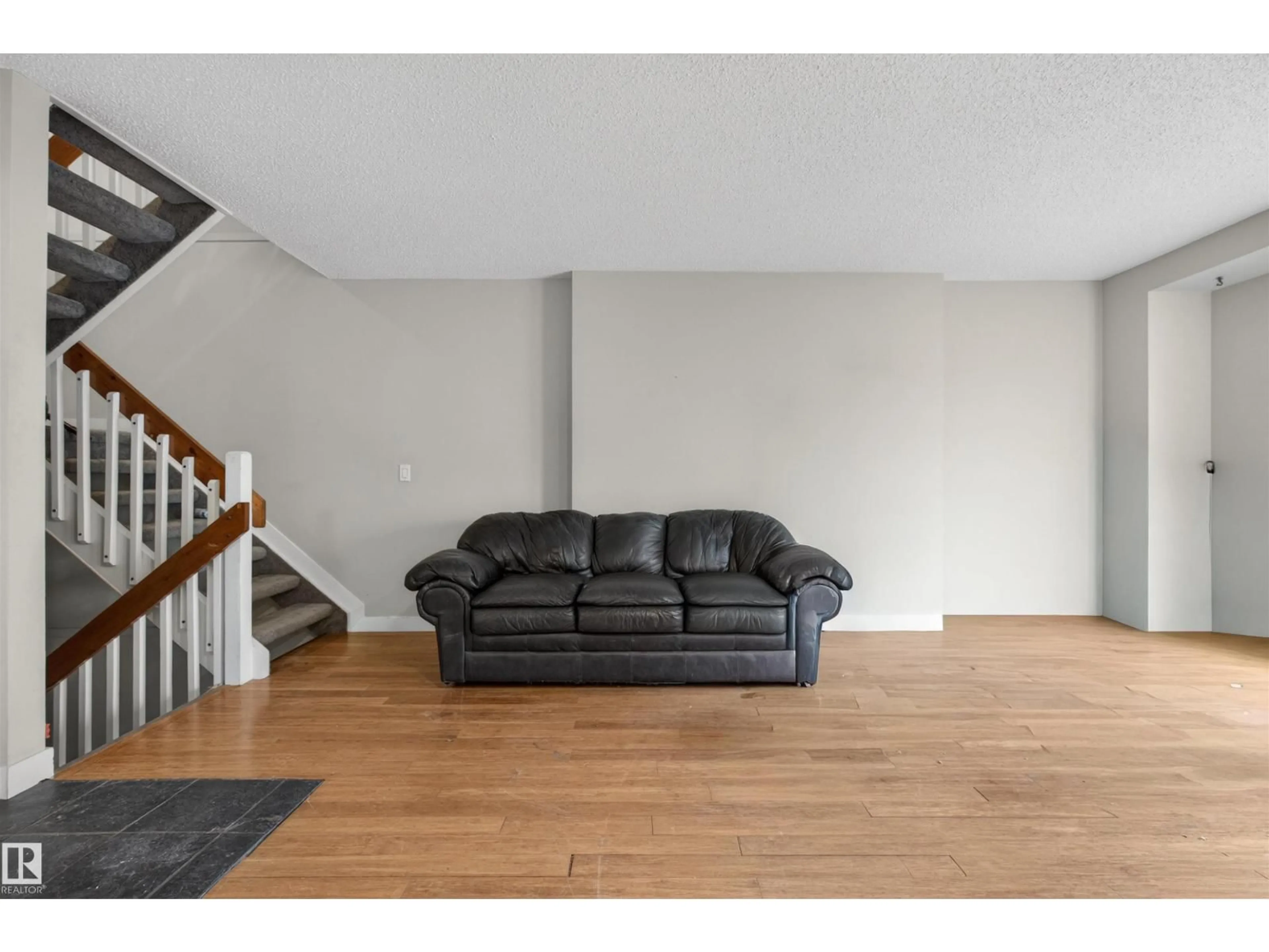 Living room with furniture, wood/laminate floor for NW - 10344A 121 ST, Edmonton Alberta T5N1K8