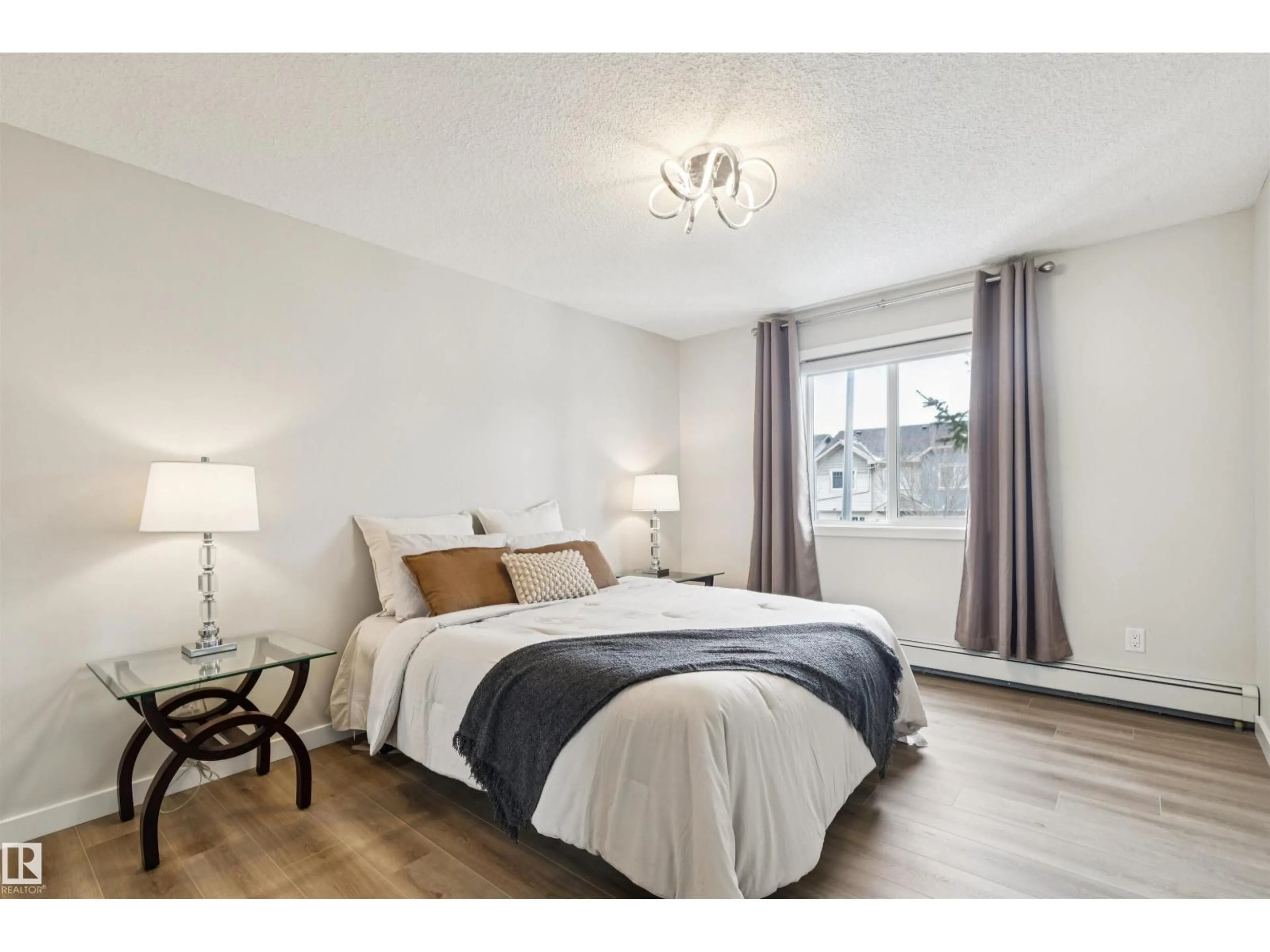 Bedroom with bed, wood/laminate floor for 206 14808 125 ST NW, Edmonton Alberta T5X0G1