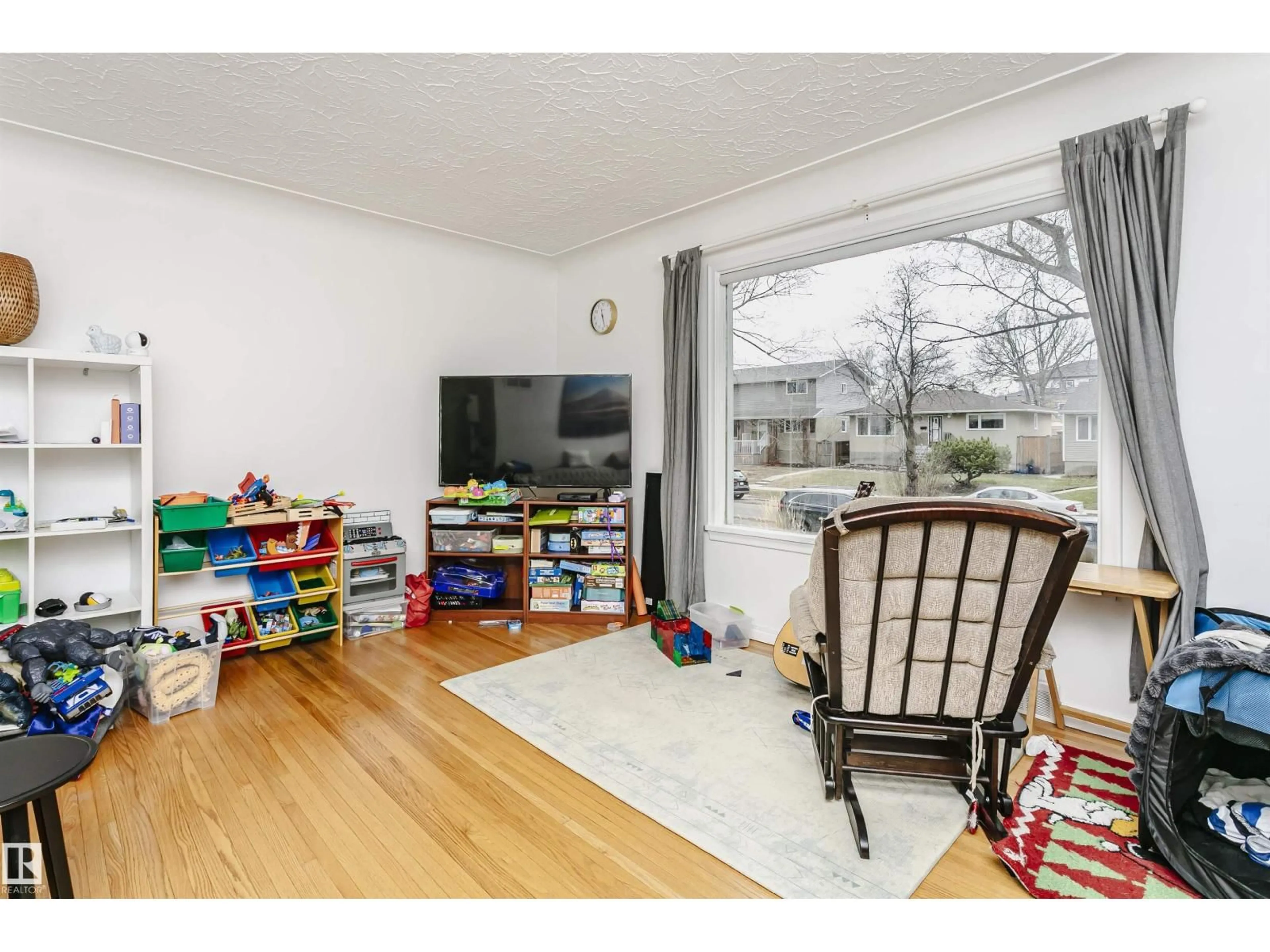 Living room with furniture, wood/laminate floor for 9760 64 AV, Edmonton Alberta T6E0J5
