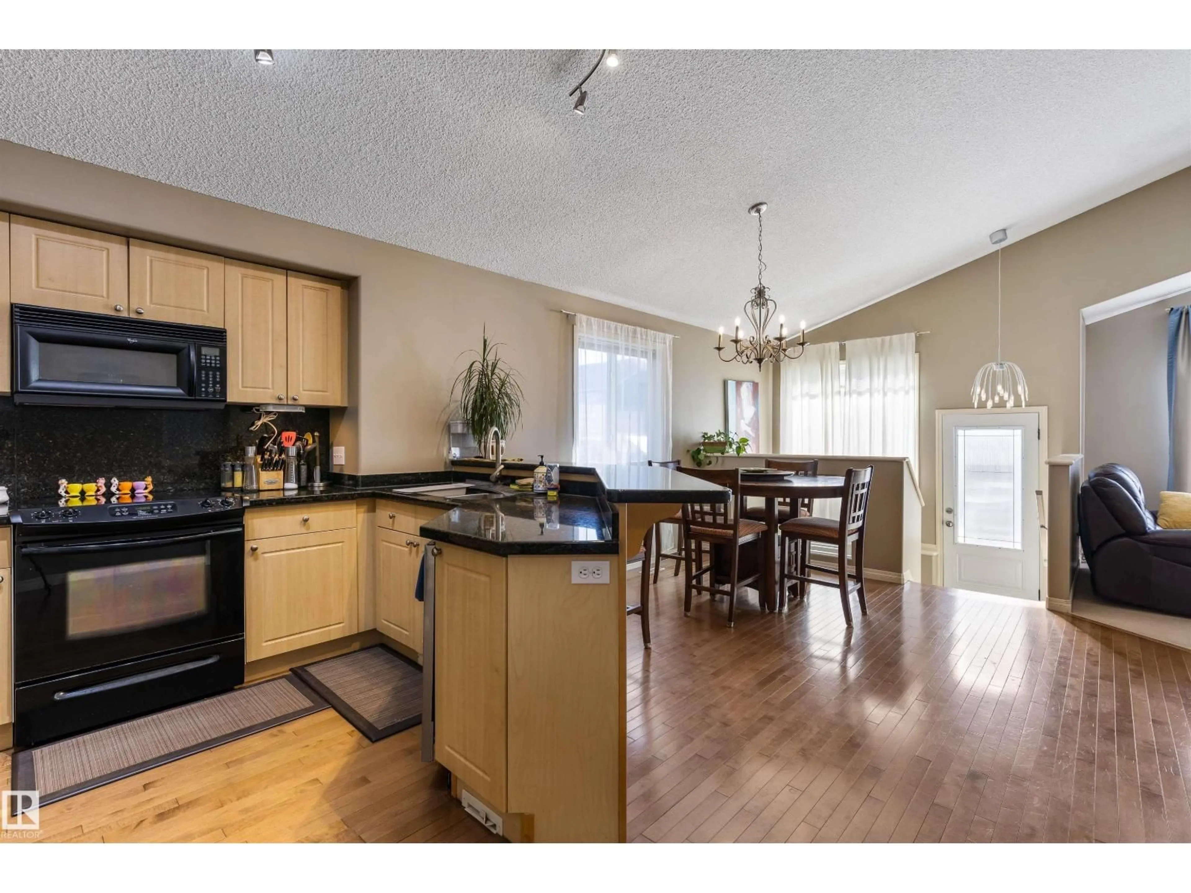 Open concept kitchen, wood/laminate floor for 17120 119 ST, Edmonton Alberta T5X6H9