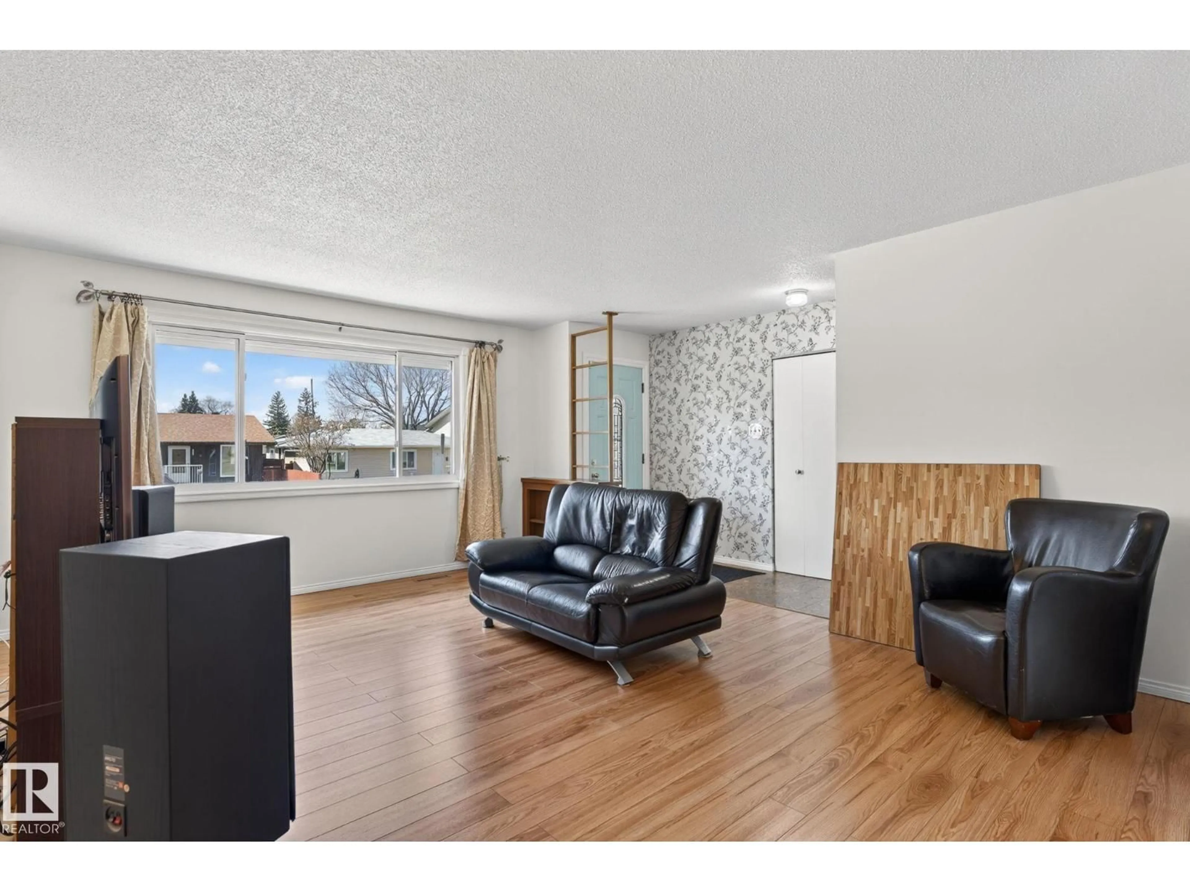 Living room with furniture, wood/laminate floor for NW - 10719 152 ST, Edmonton Alberta T5P1Z2