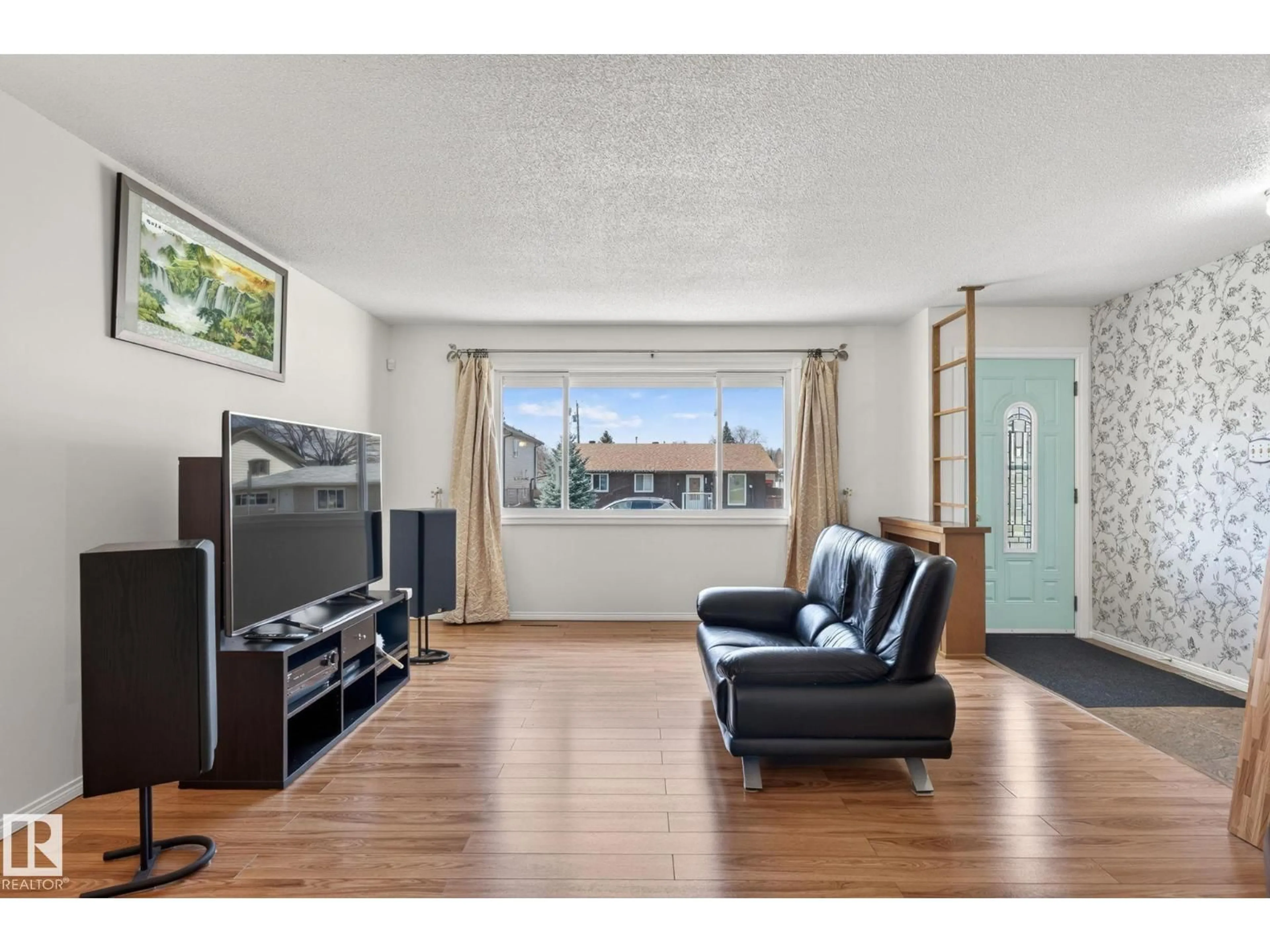 Living room with furniture, wood/laminate floor for NW - 10719 152 ST, Edmonton Alberta T5P1Z2