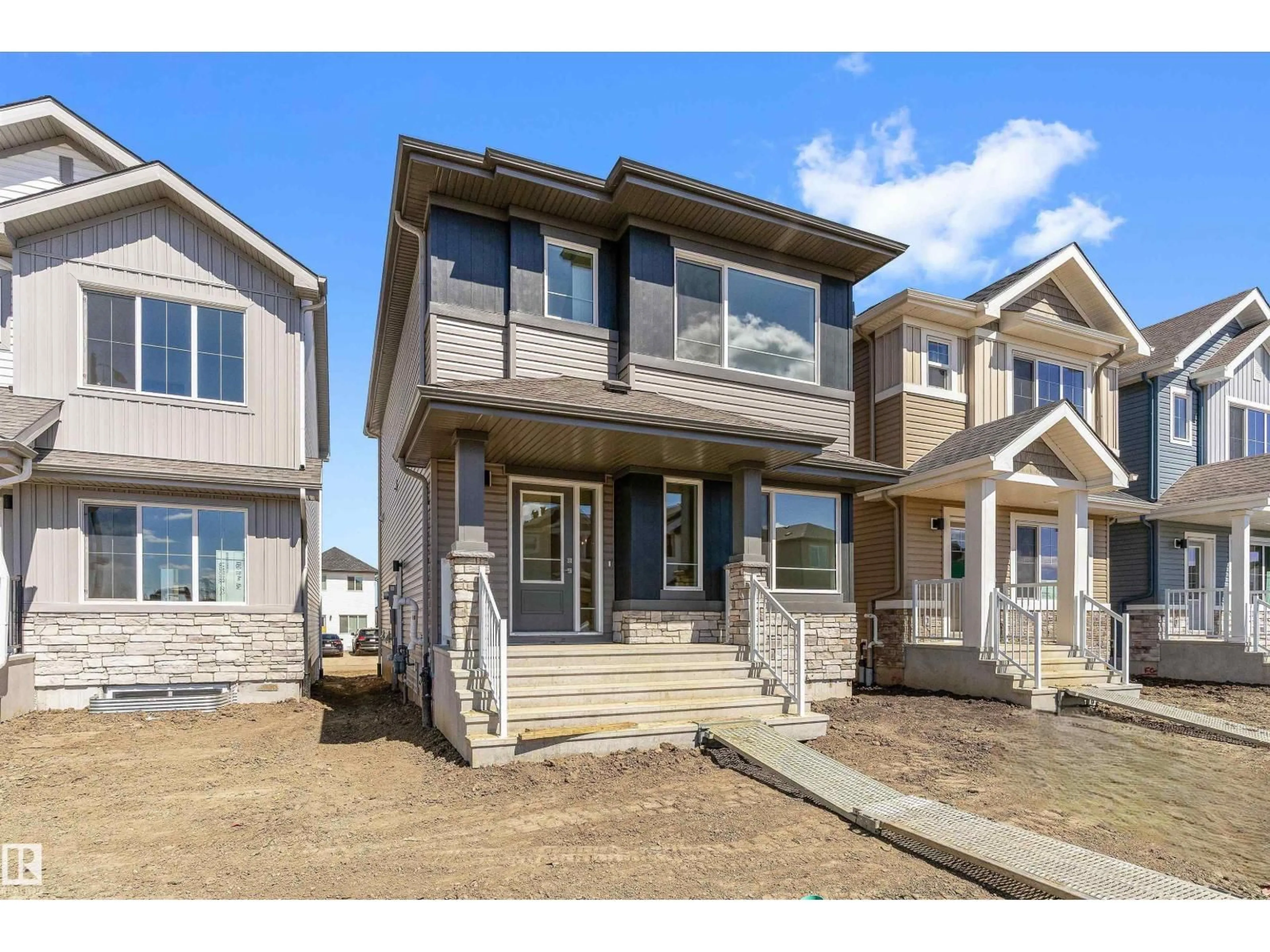 Home with vinyl exterior material, street for 1056 14 AV, Edmonton Alberta T6T2W7
