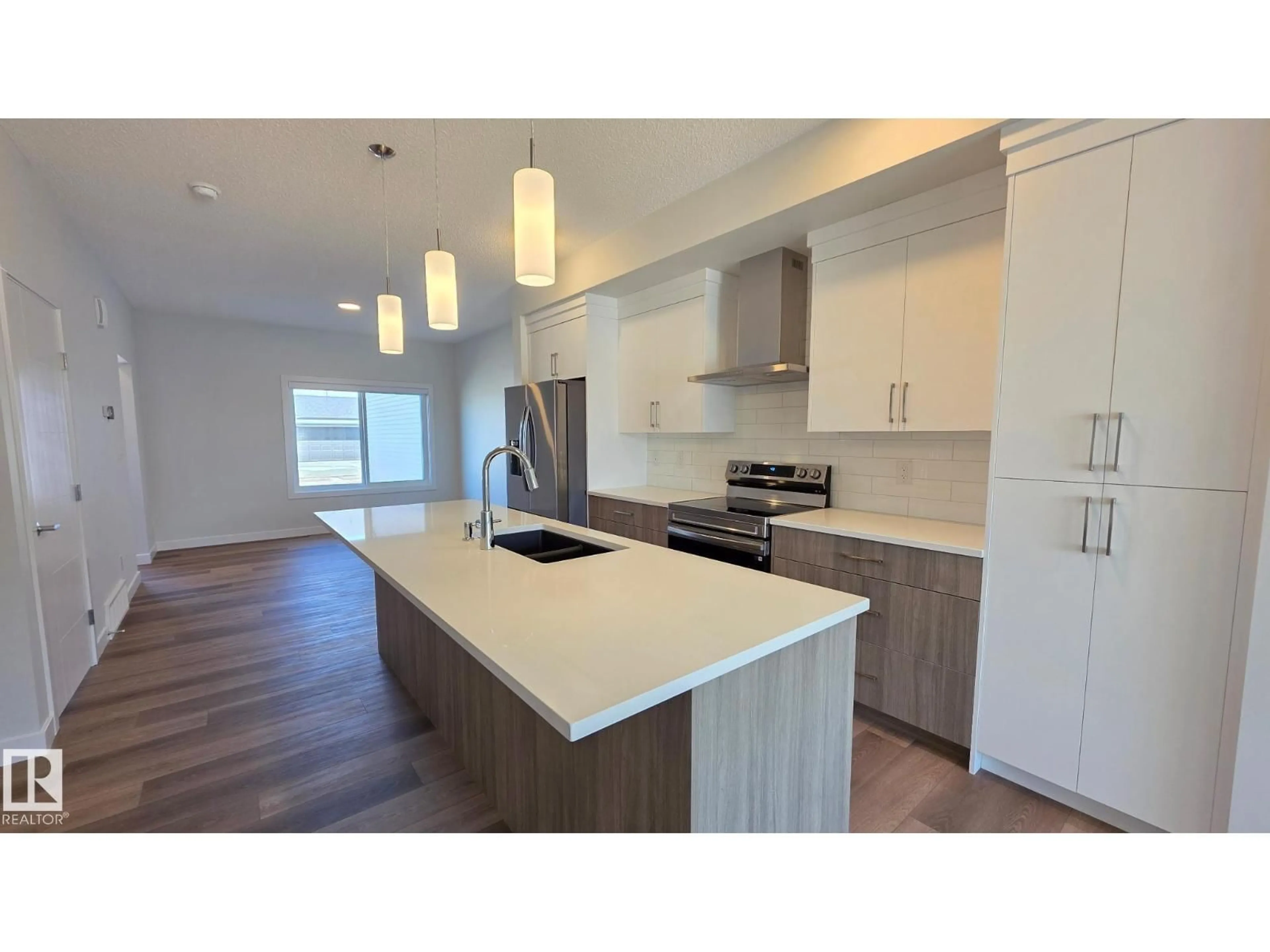 Open concept kitchen, wood/laminate floor for 301 BRAE WY, Leduc Alberta T9E1T7