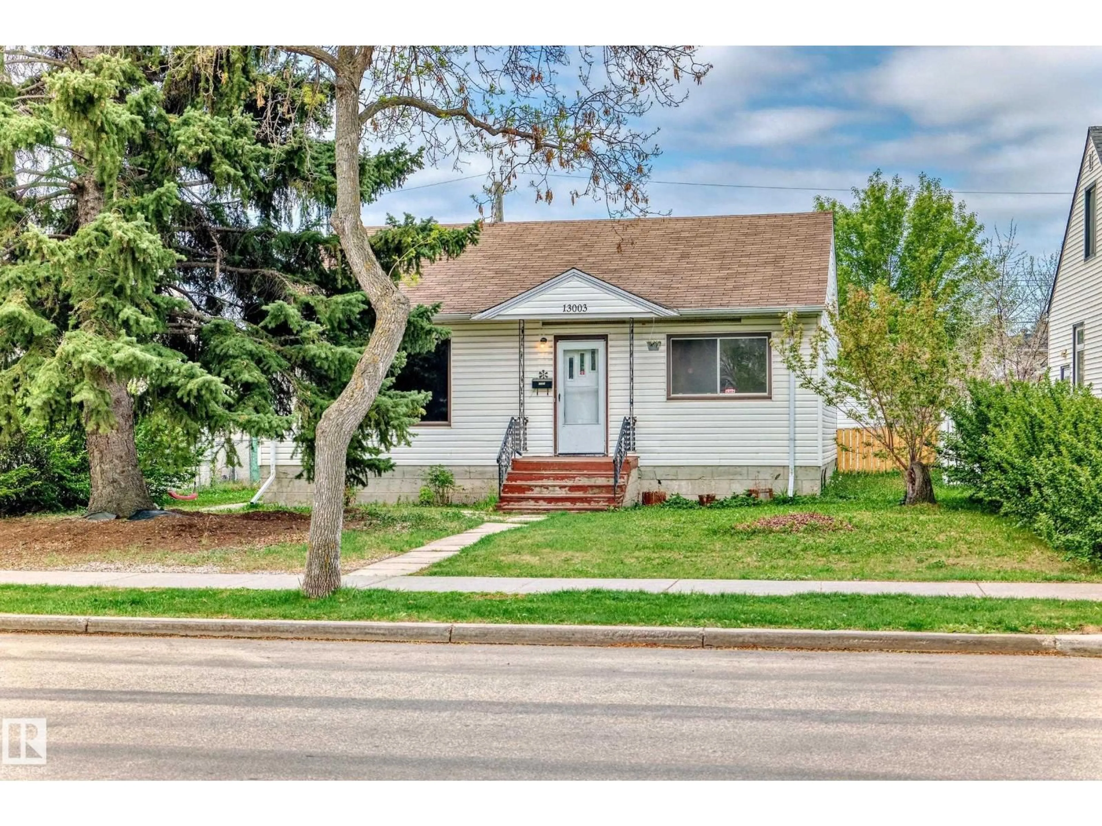 Home with vinyl exterior material, street for 13003 SHERBROOKE AV, Edmonton Alberta T5L4E6