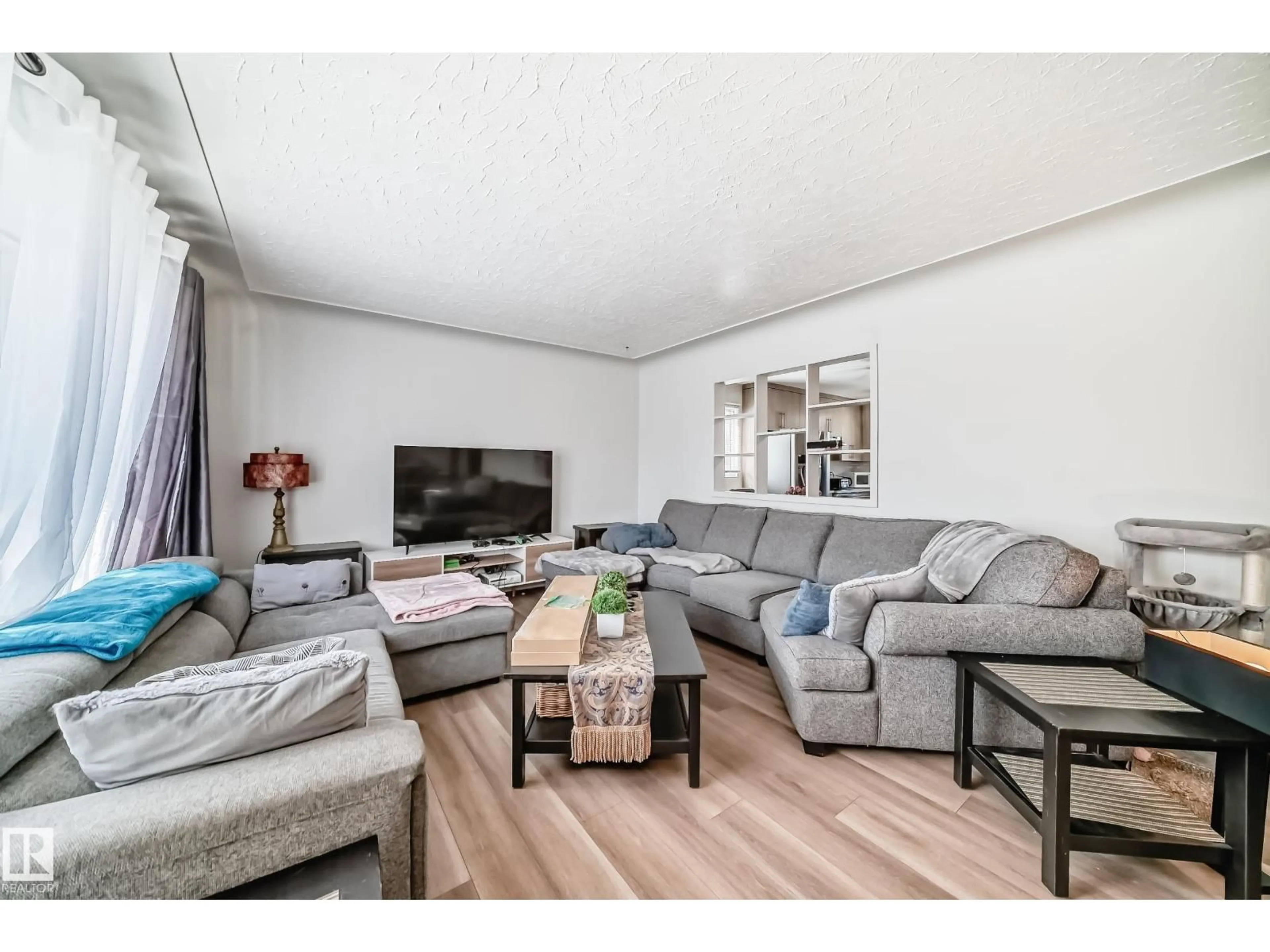 Living room with furniture, wood/laminate floor for NW - 13524 123A ST, Edmonton Alberta T5L2Z2