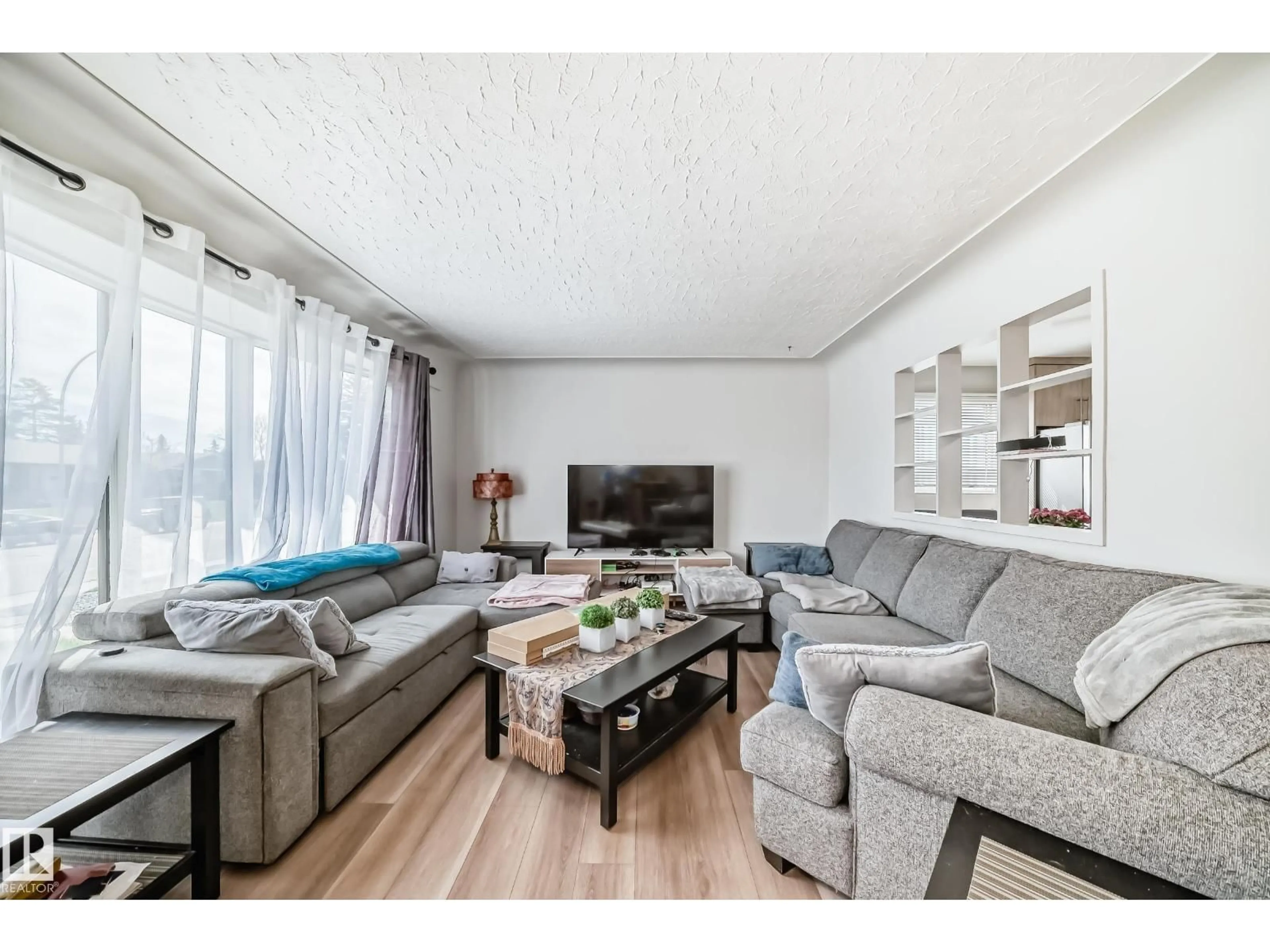 Living room with furniture, wood/laminate floor for NW - 13524 123A ST, Edmonton Alberta T5L2Z2