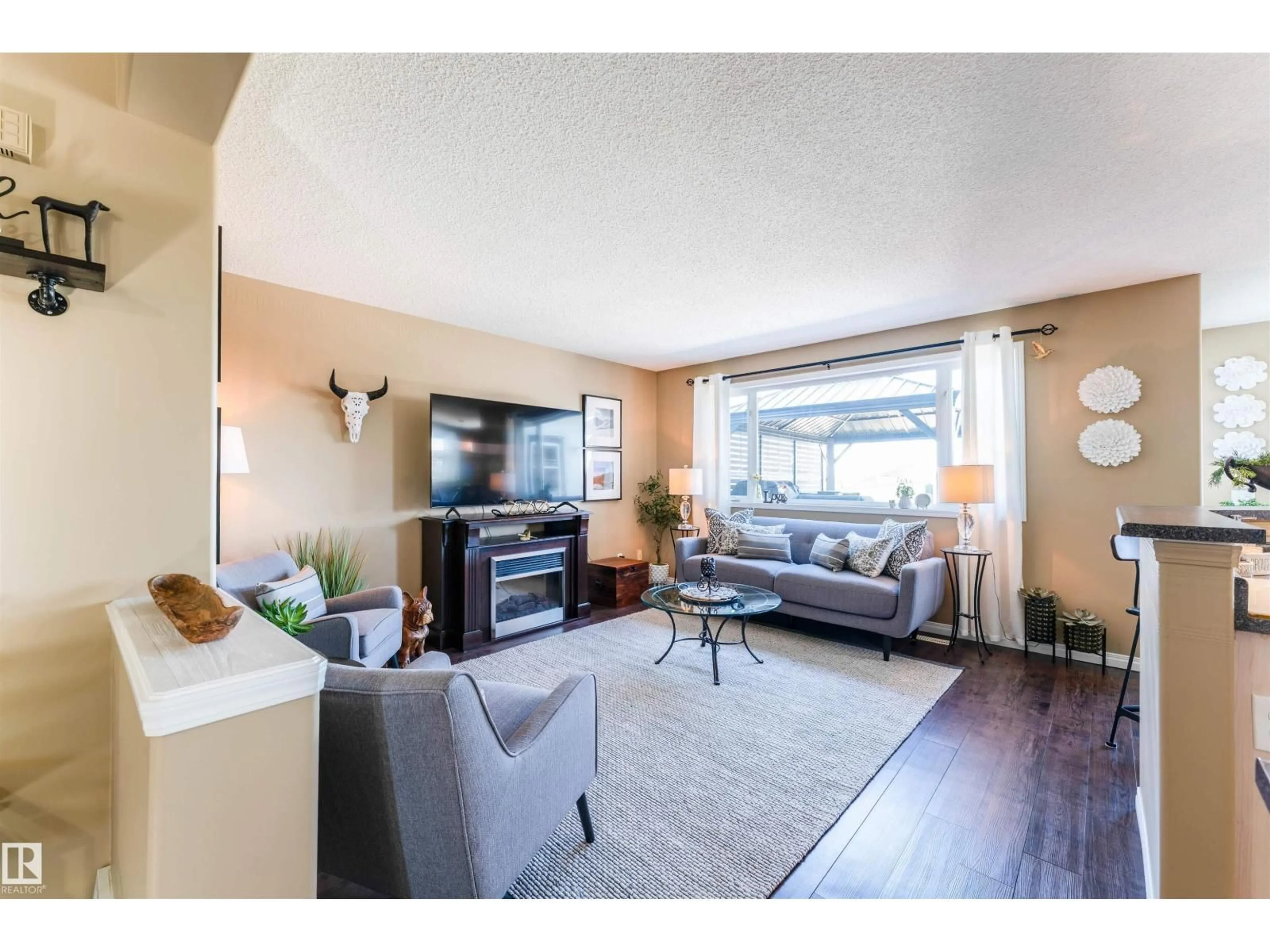 Living room with furniture, wood/laminate floor for 847 BLACKLOCK WY, Edmonton Alberta T6W1C6