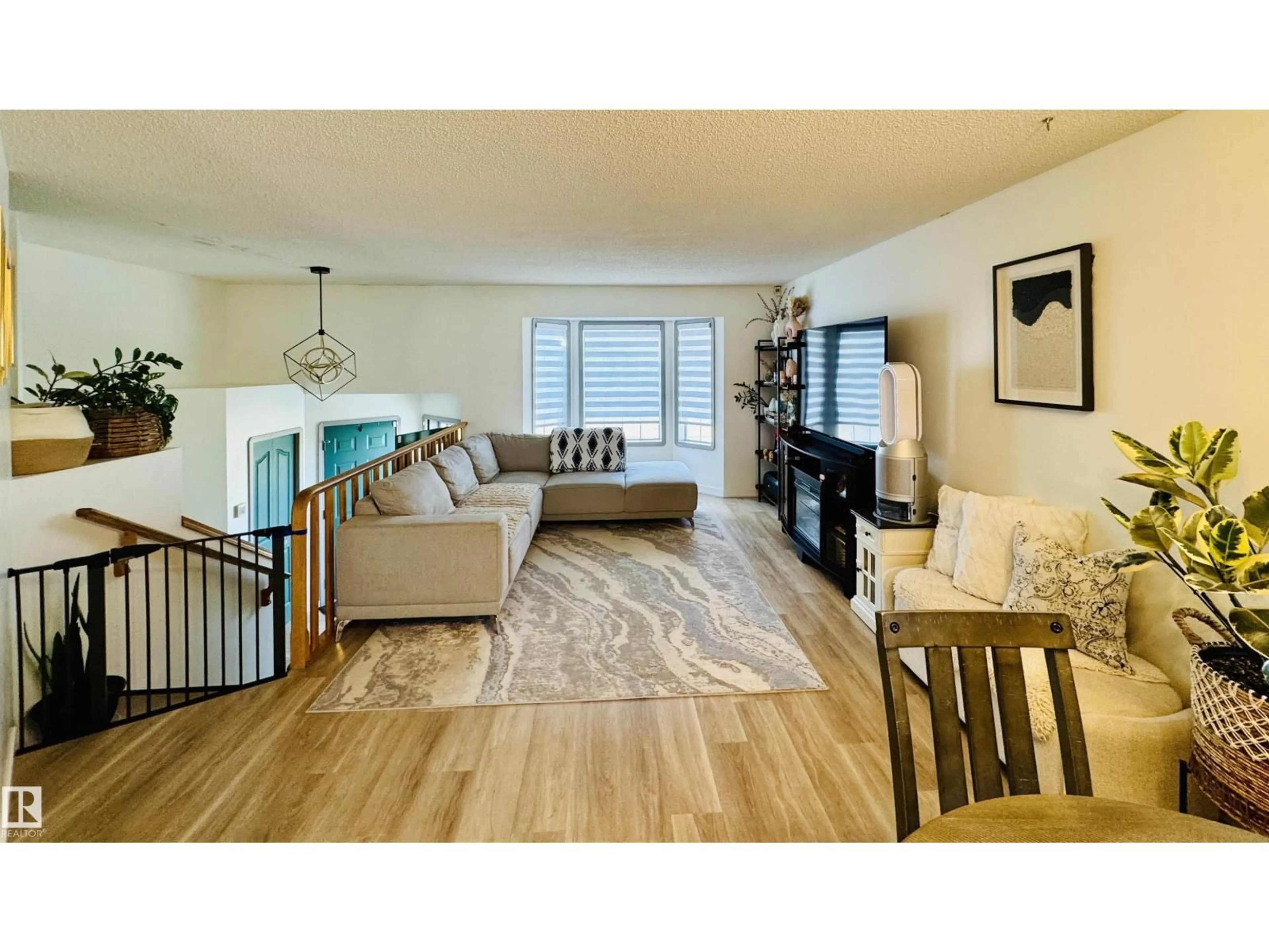 Living room with furniture, wood/laminate floor for 5537 54 AV, St. Paul Town Alberta T0A3A1