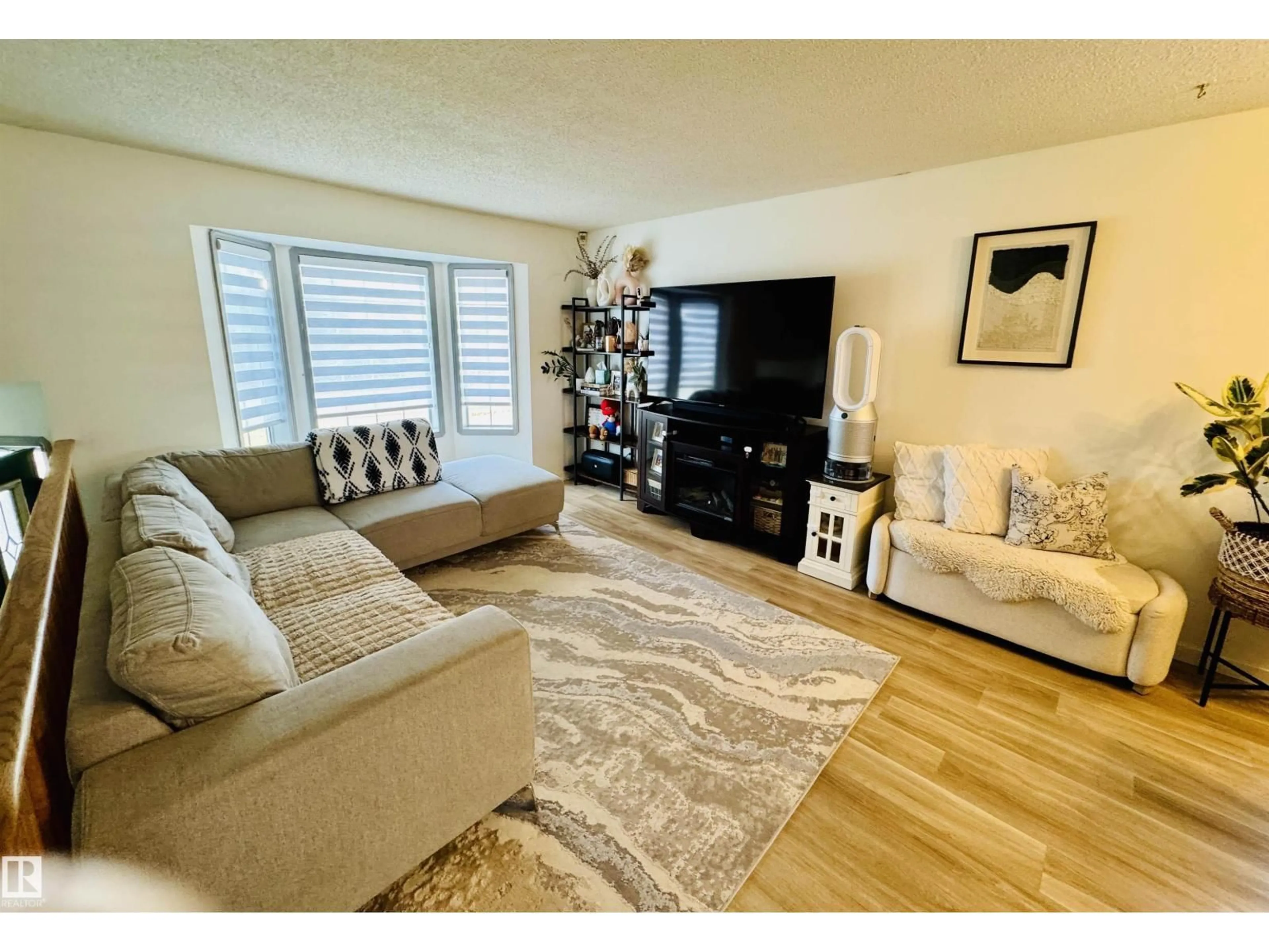 Living room with furniture, wood/laminate floor for 5537 54 AV, St. Paul Town Alberta T0A3A1