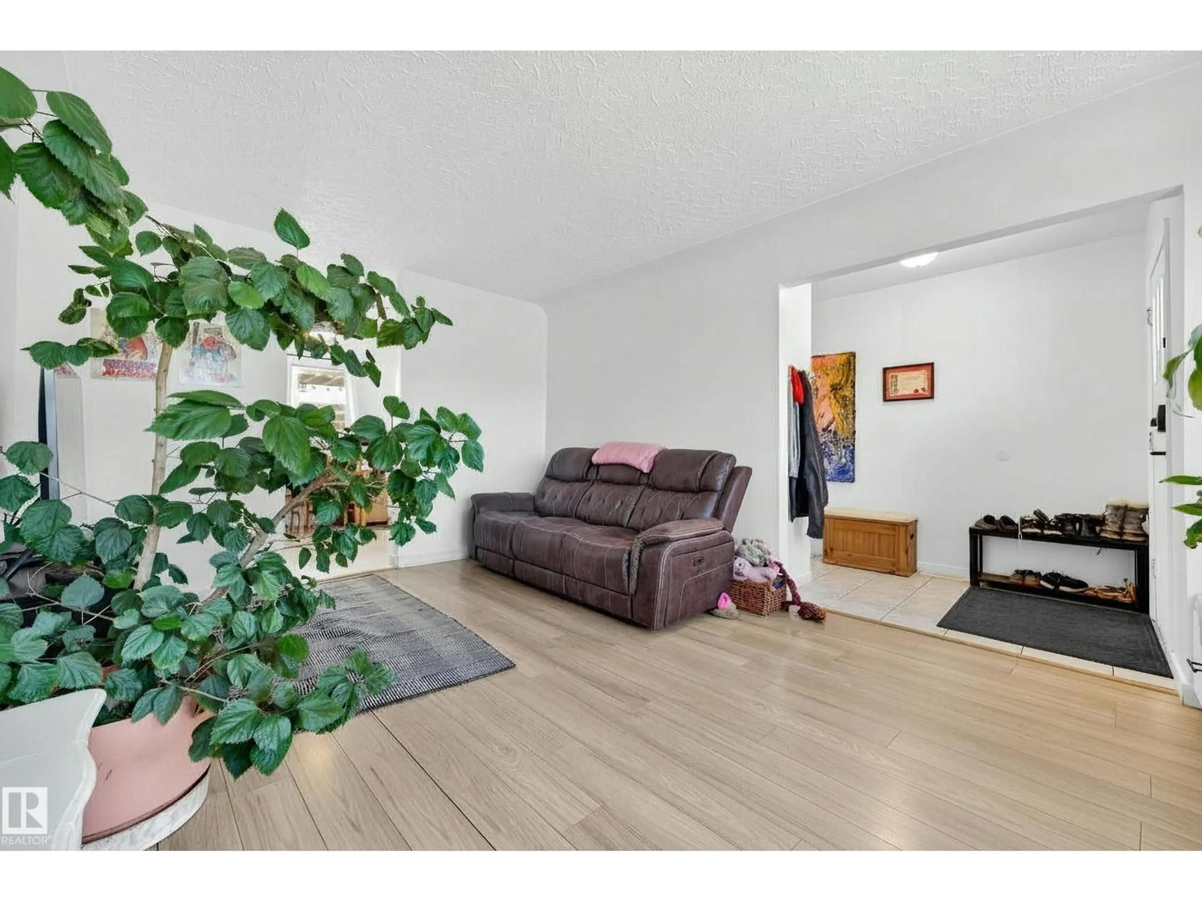 Living room with furniture, wood/laminate floor for 13620 119 AV, Edmonton Alberta T5L2N6