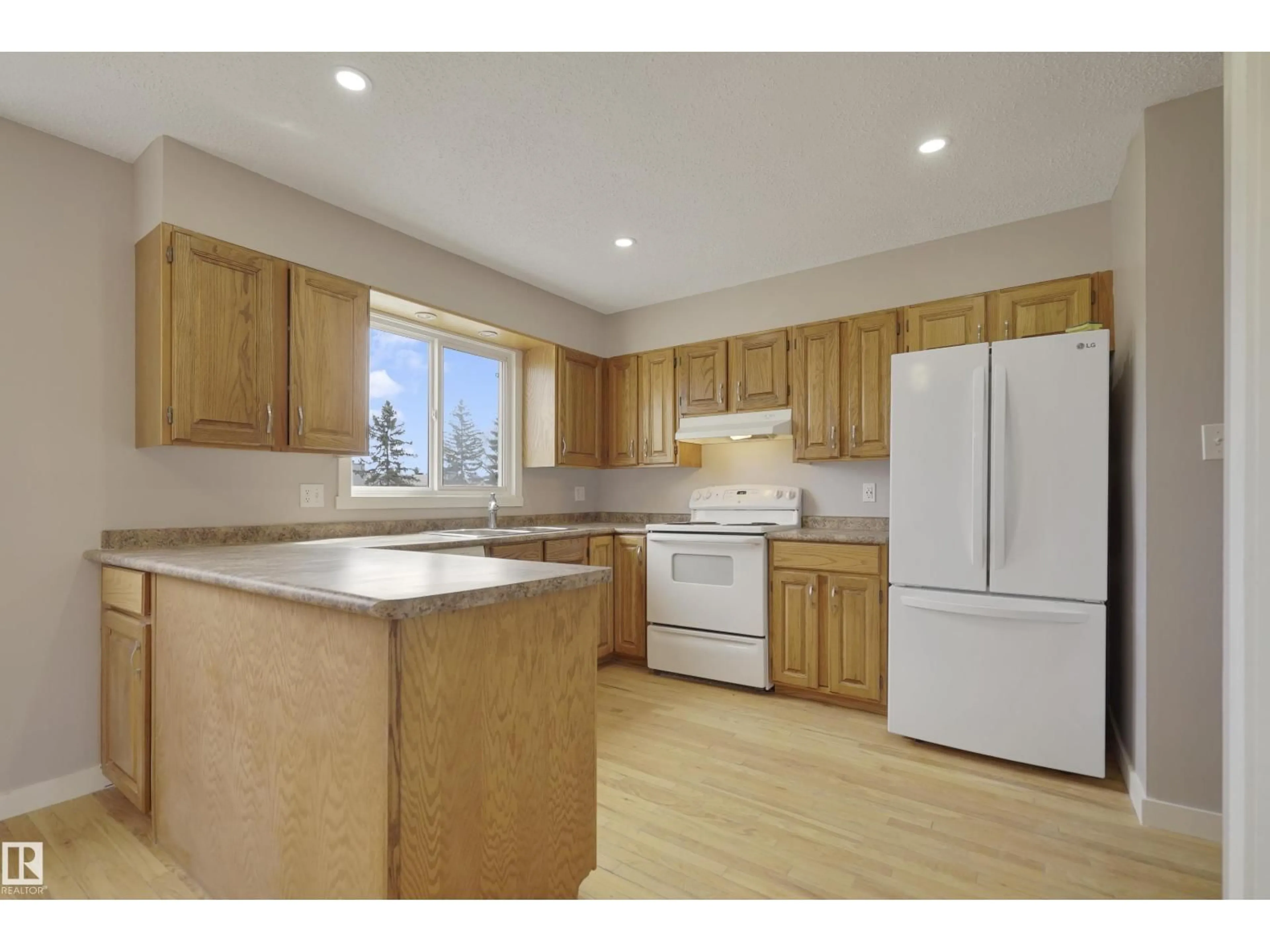 Open concept kitchen, wood/laminate floor for NW - 10612 158 AV, Edmonton Alberta T5X4H5