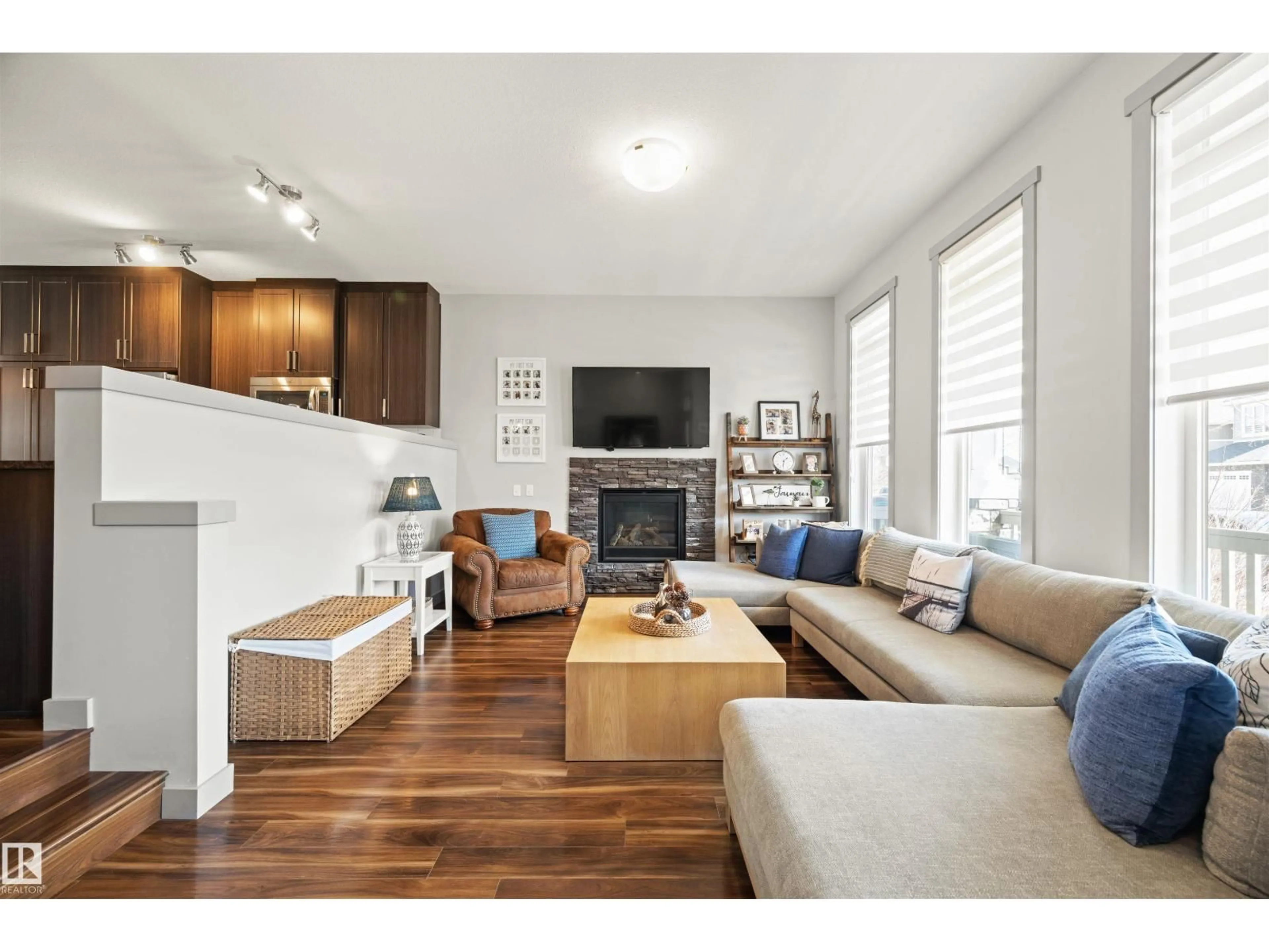Living room with furniture, wood/laminate floor for SW - 16460 15 AV, Edmonton Alberta T6W2Z7