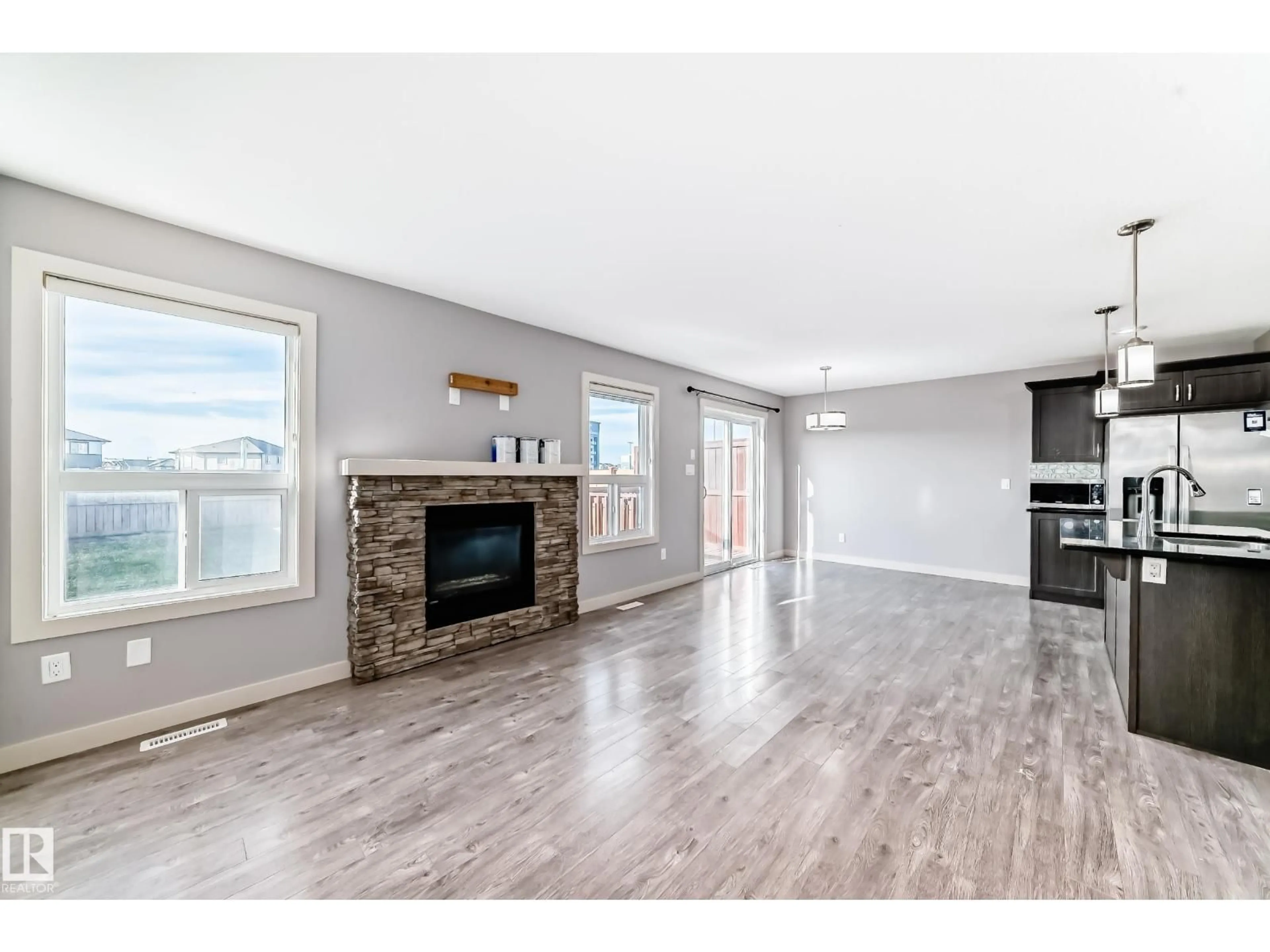 Open concept kitchen, wood/laminate floor for NW - 1669 HAMMOND CR, Edmonton Alberta T6M0N3