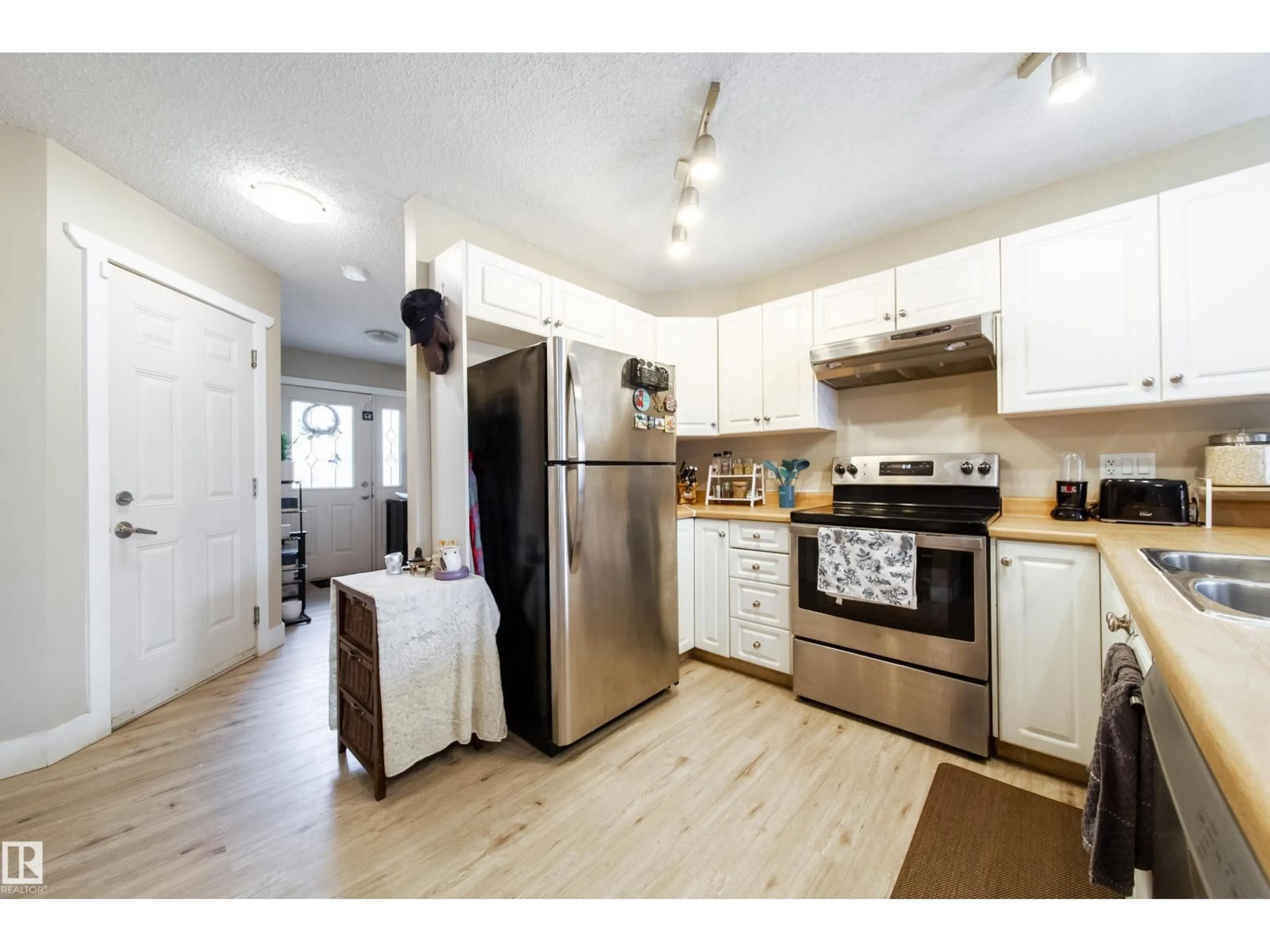 Open concept kitchen, wood/laminate floor for 118 - 5001 62 ST, Beaumont Alberta T4X0C7