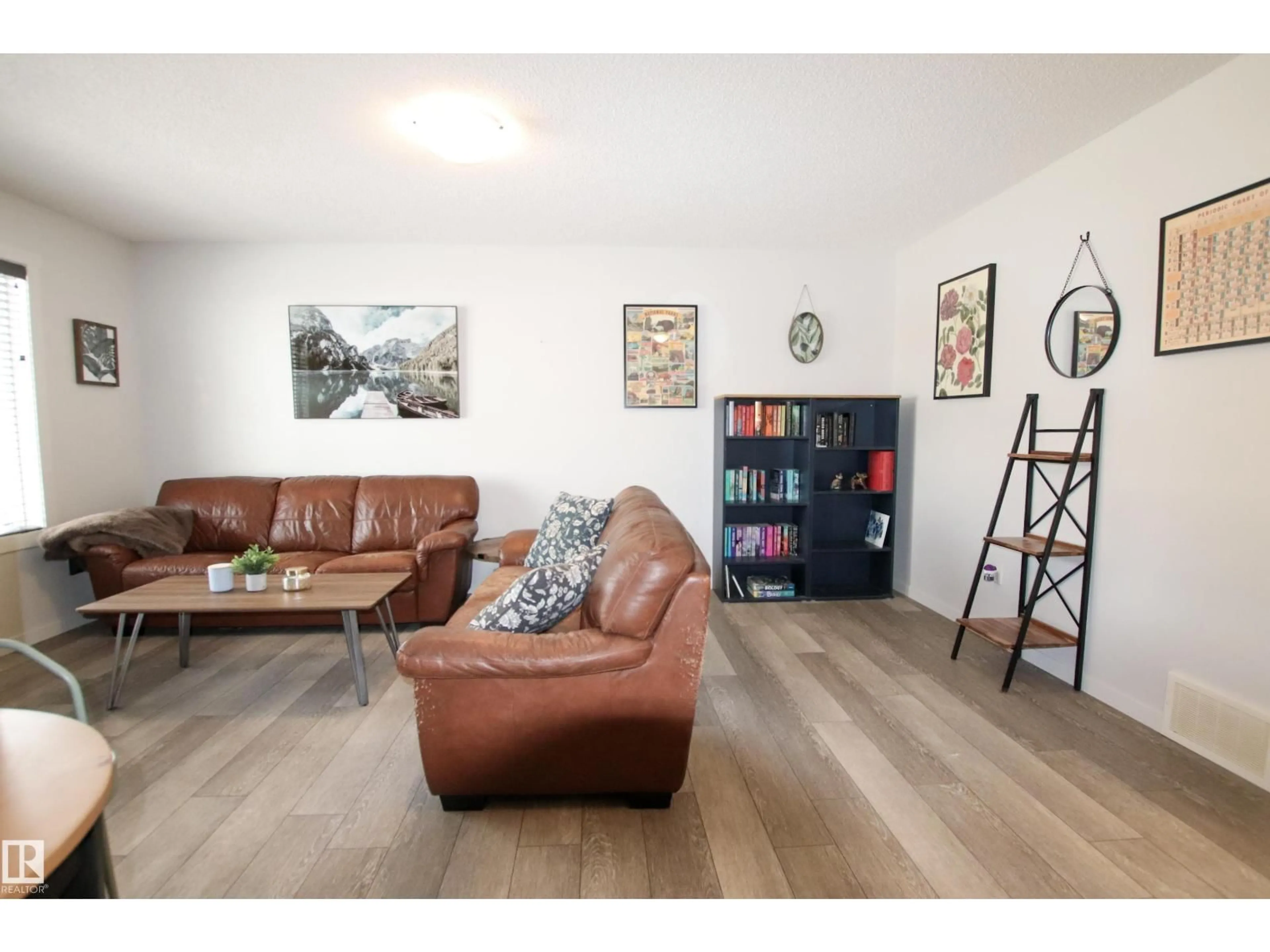 Living room with furniture, wood/laminate floor for 2509 14 AV, Edmonton Alberta T6T2J6