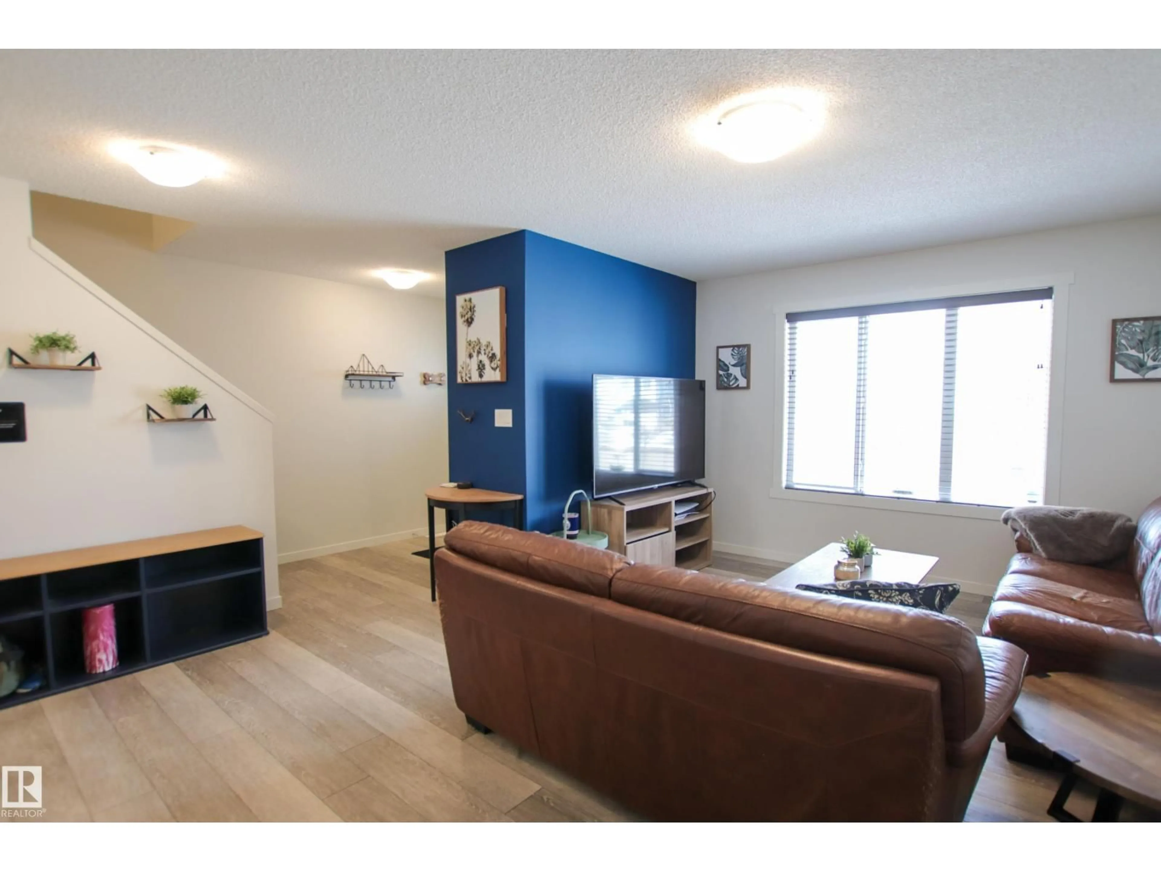 Living room with furniture, wood/laminate floor for 2509 14 AV, Edmonton Alberta T6T2J6