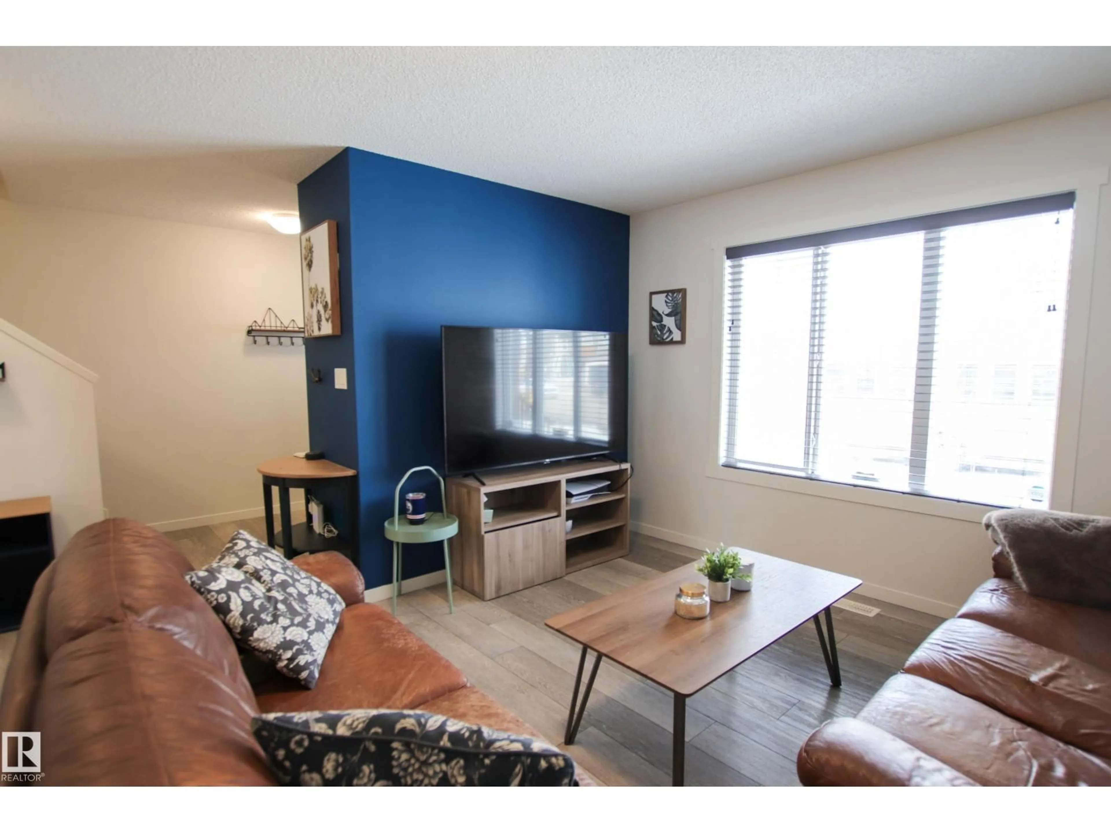 Living room with furniture, wood/laminate floor for 2509 14 AV, Edmonton Alberta T6T2J6