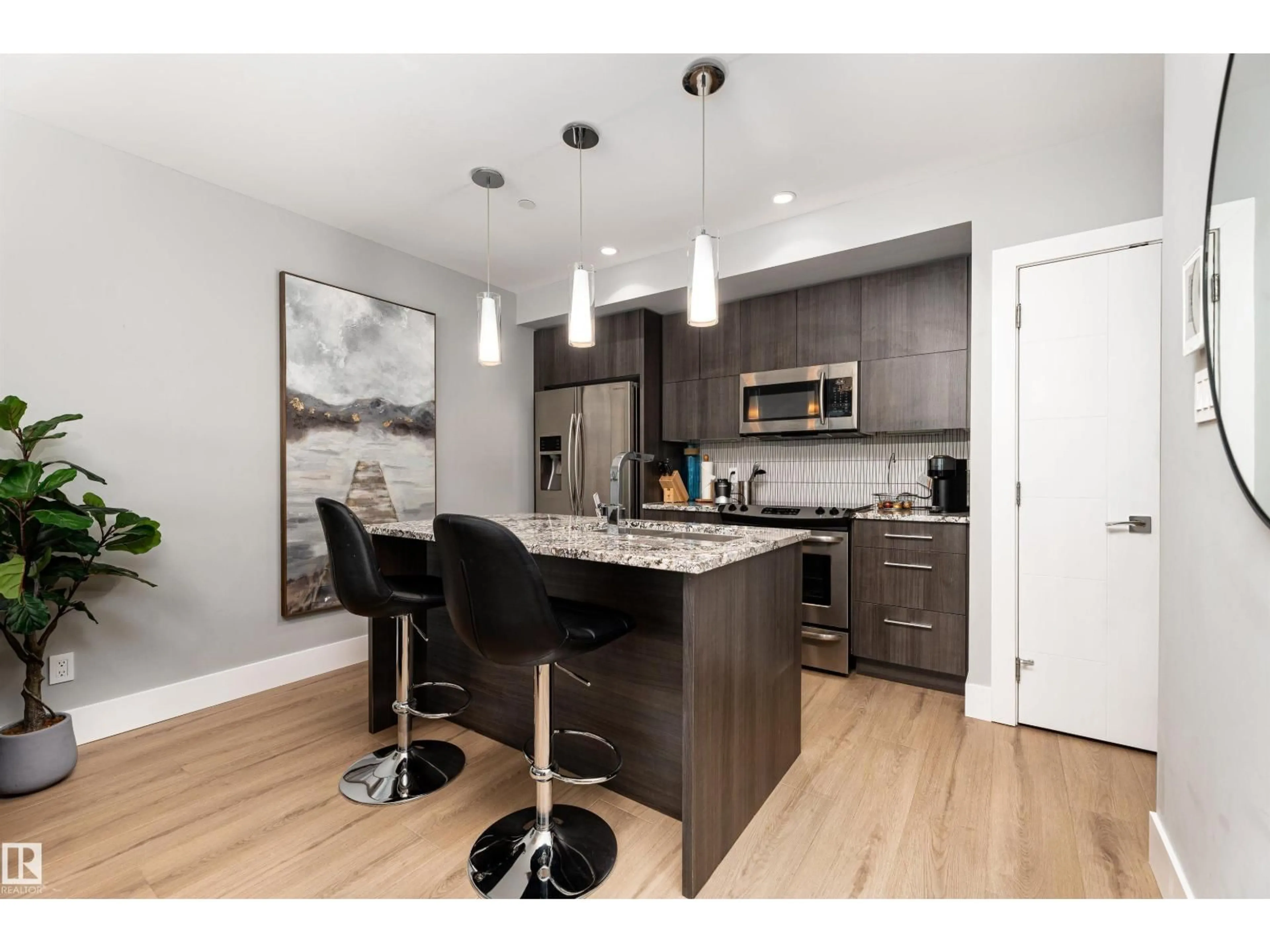 Open concept kitchen, wood/laminate floor for 1404 - 11969 JASPER AV, Edmonton Alberta T5K0P1