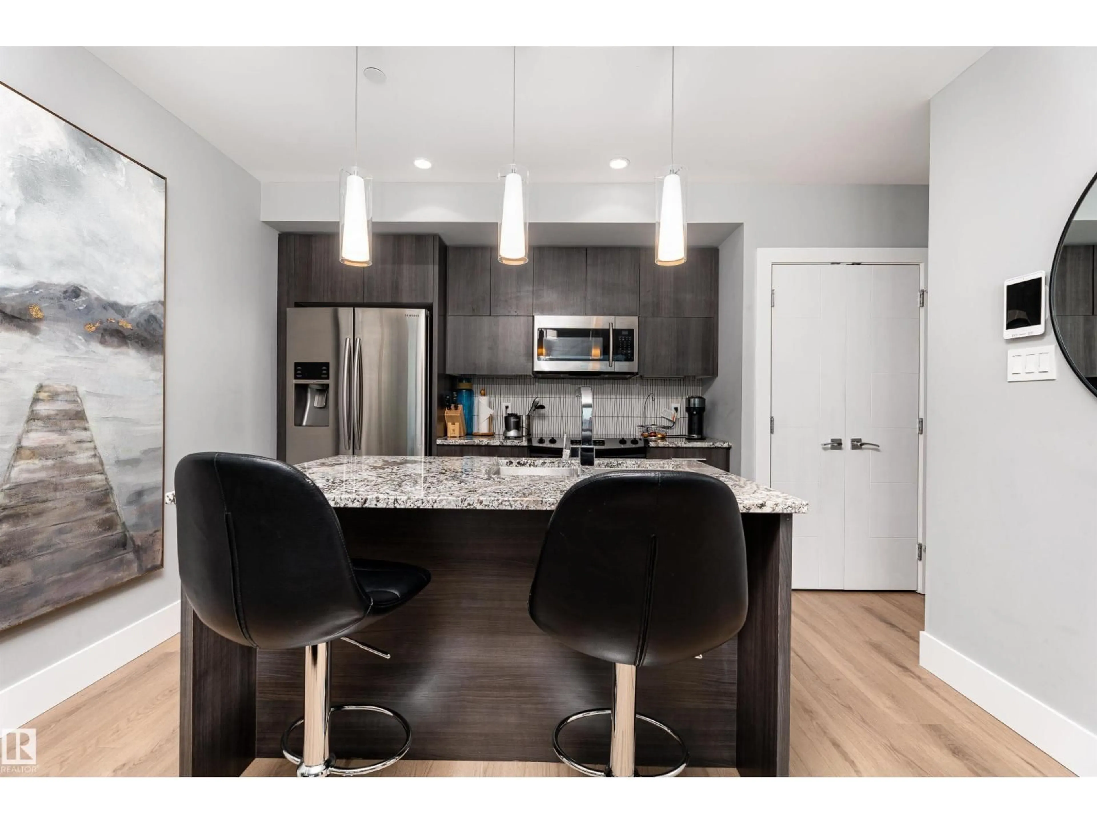 Open concept kitchen, wood/laminate floor for 1404 - 11969 JASPER AV, Edmonton Alberta T5K0P1
