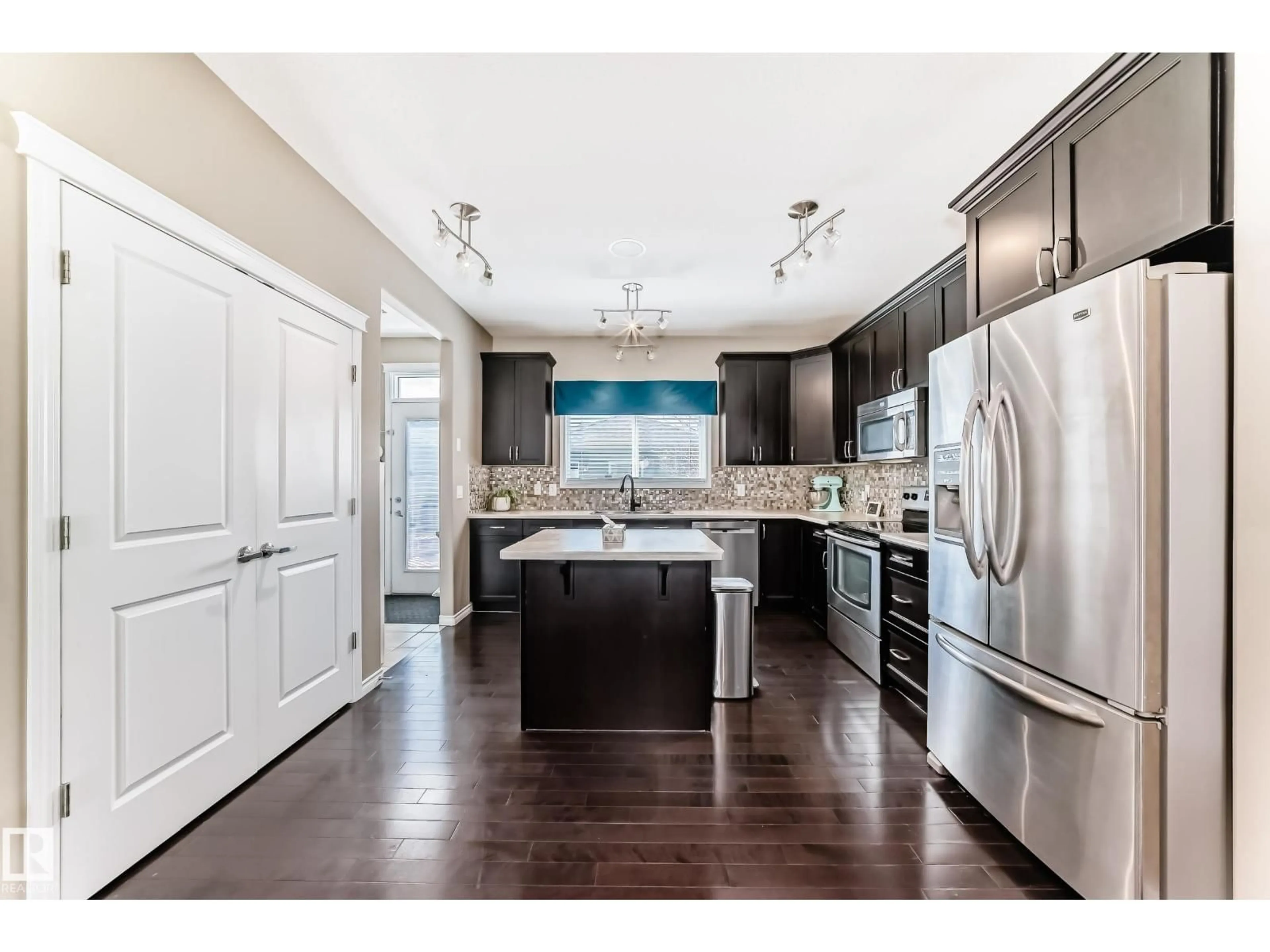 Open concept kitchen, wood/laminate floor for 5020 ORCHARDS GATE SW, Edmonton Alberta T6X0X5