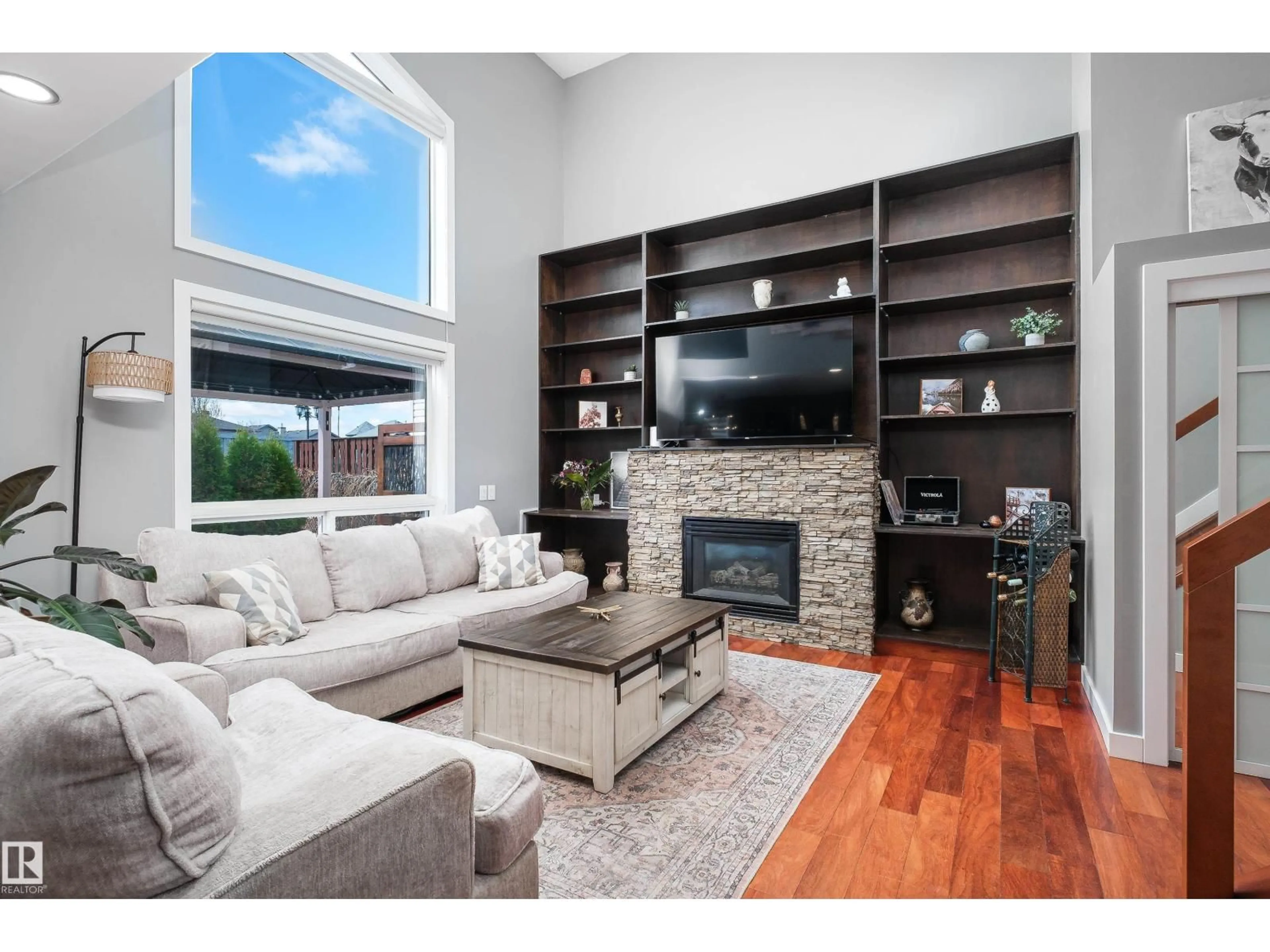 Living room with furniture, wood/laminate floor for 437 KLARVATTEN LAKE WD, Edmonton Alberta T5Z3B9