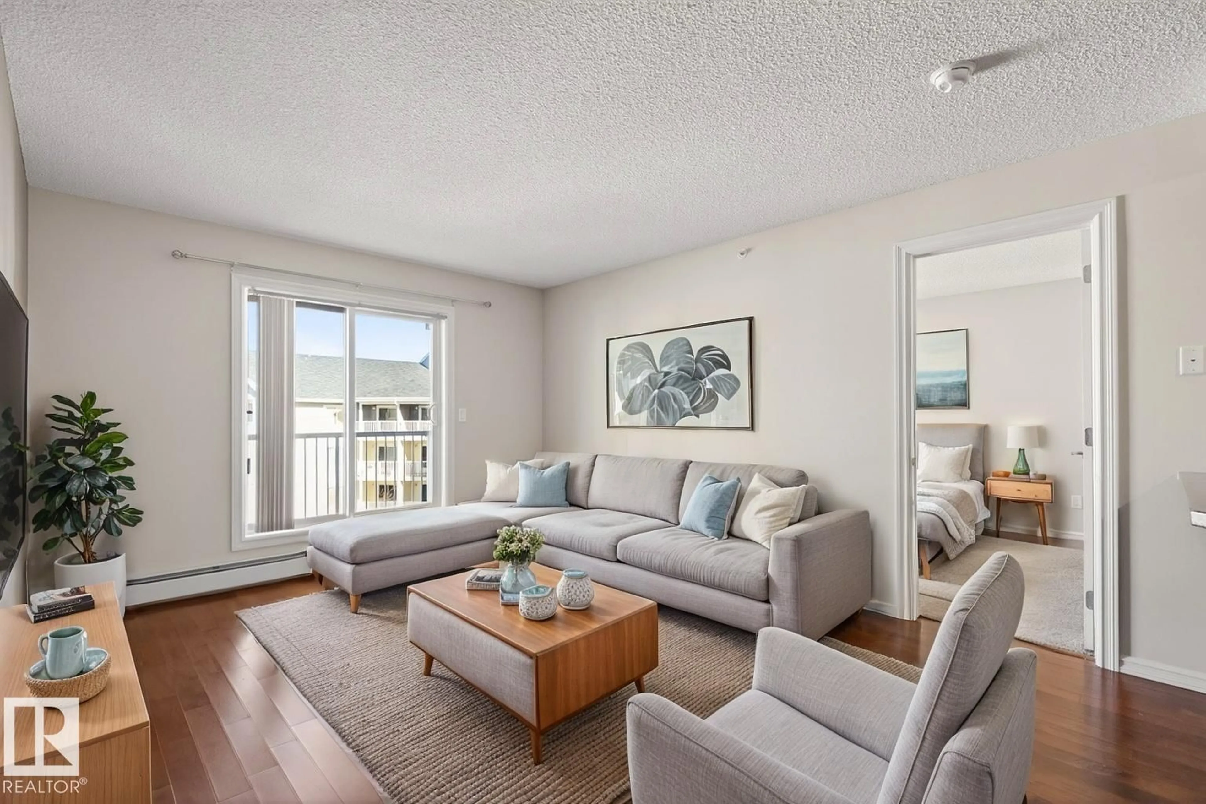 Living room with furniture, wood/laminate floor for 404 - 2208 44 AV NW, Edmonton Alberta T6T0G5