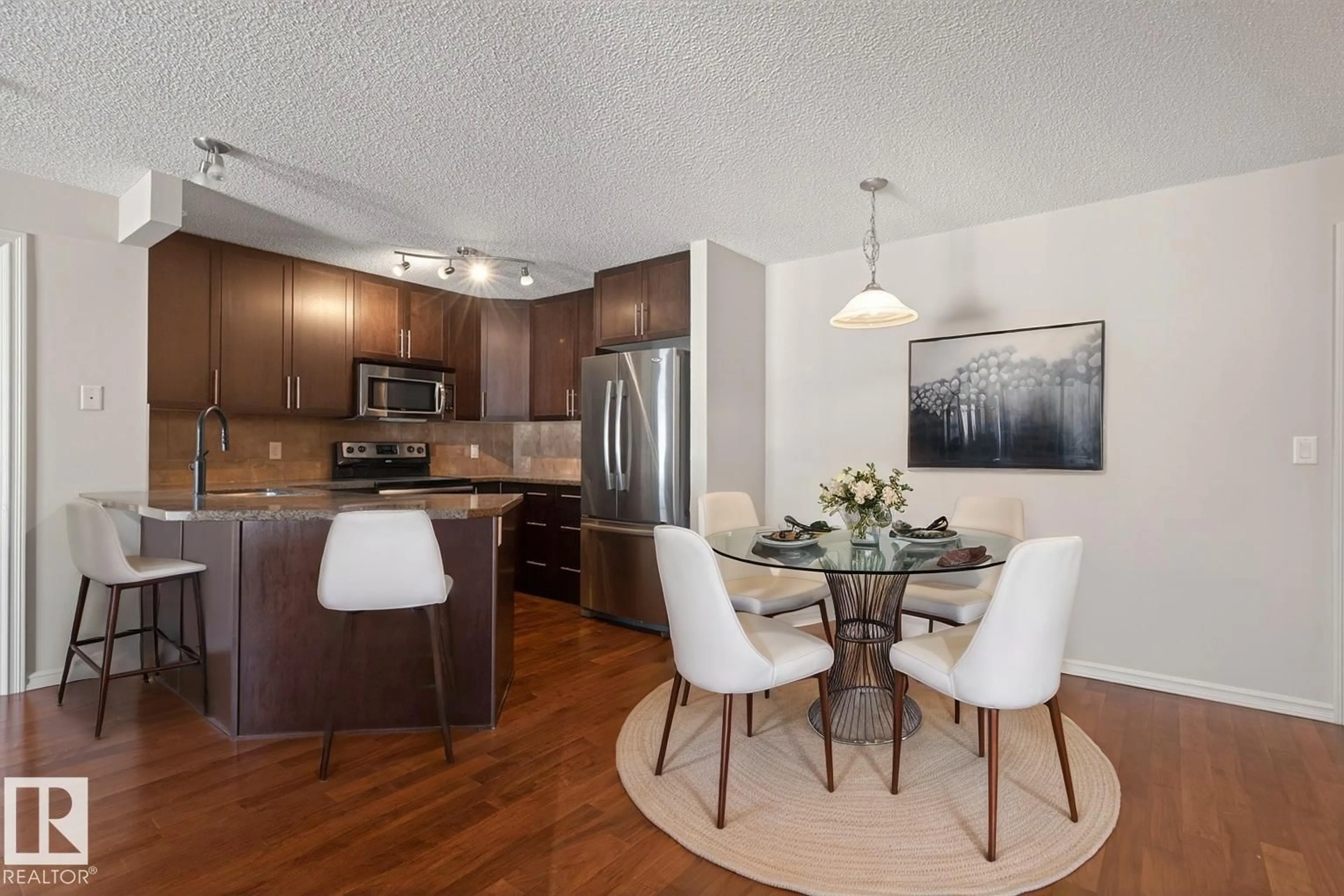 Open concept kitchen, wood/laminate floor for 404 - 2208 44 AV NW, Edmonton Alberta T6T0G5