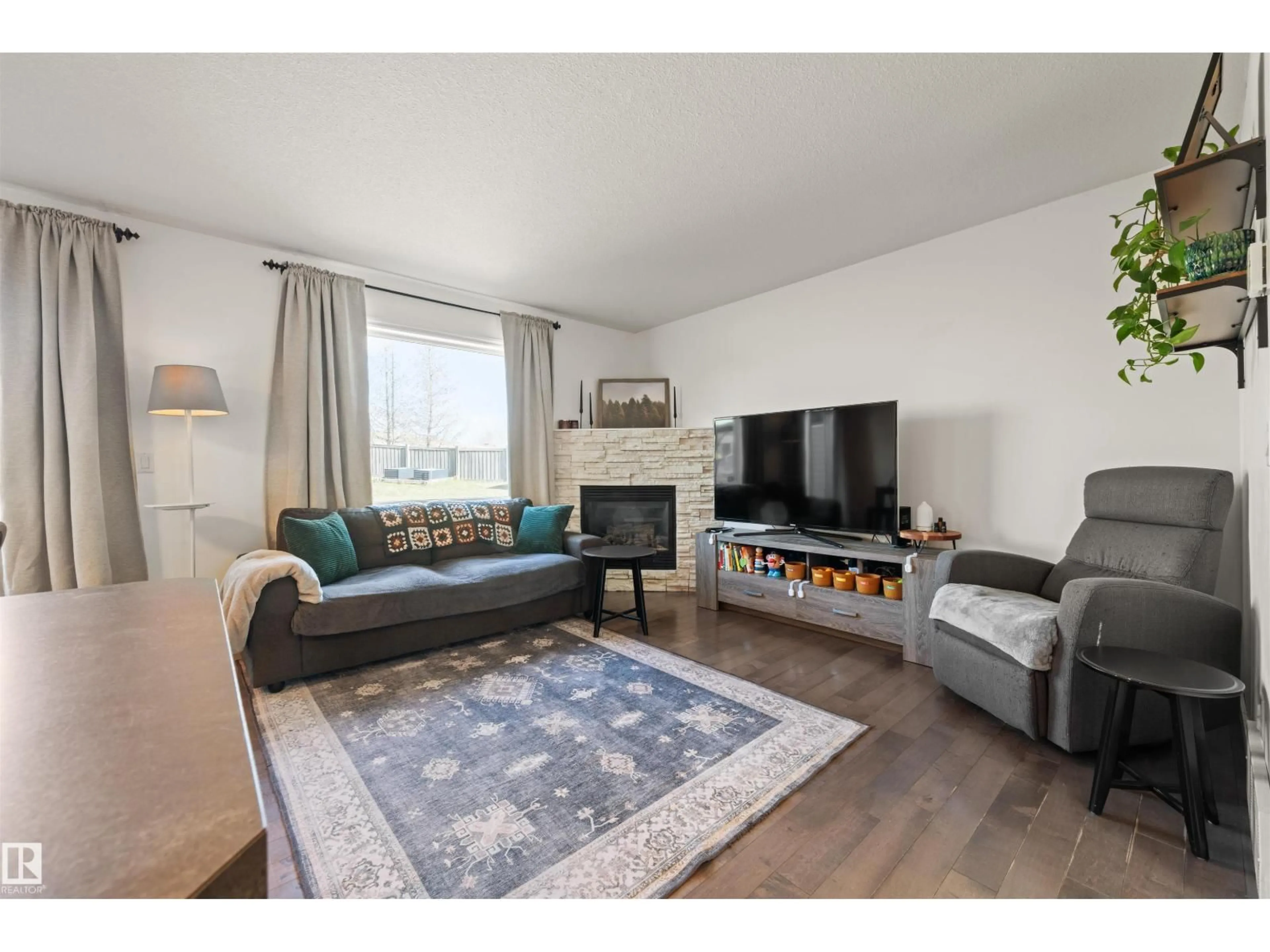 Living room with furniture, wood/laminate floor for 21324 46 AV, Edmonton Alberta T6M0H1