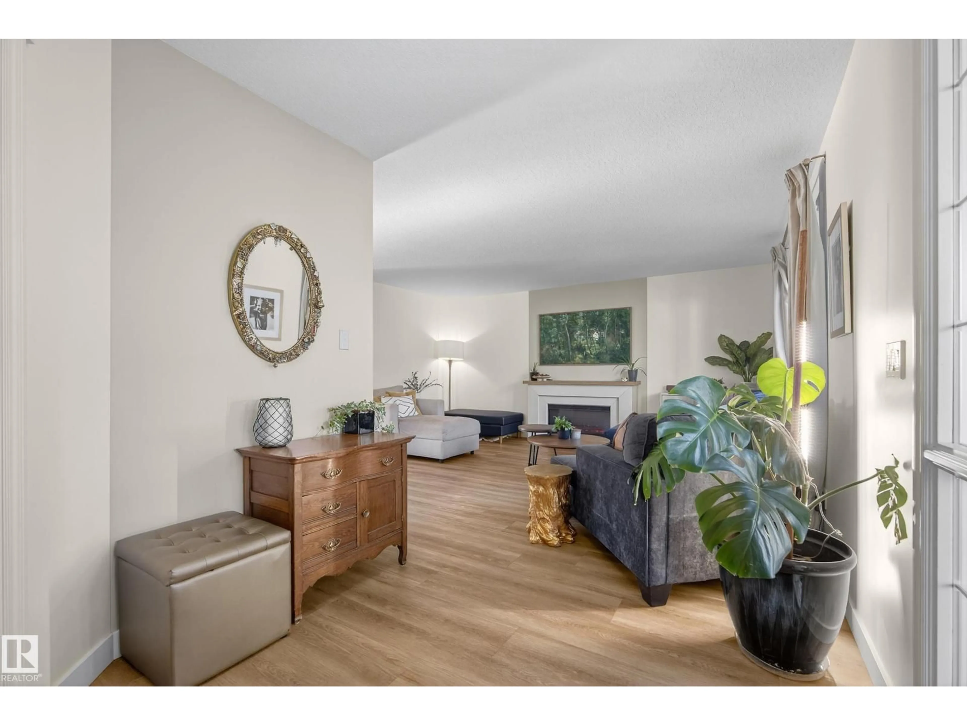 Living room with furniture, wood/laminate floor for 8705 92A AV, Edmonton Alberta T6C4G6