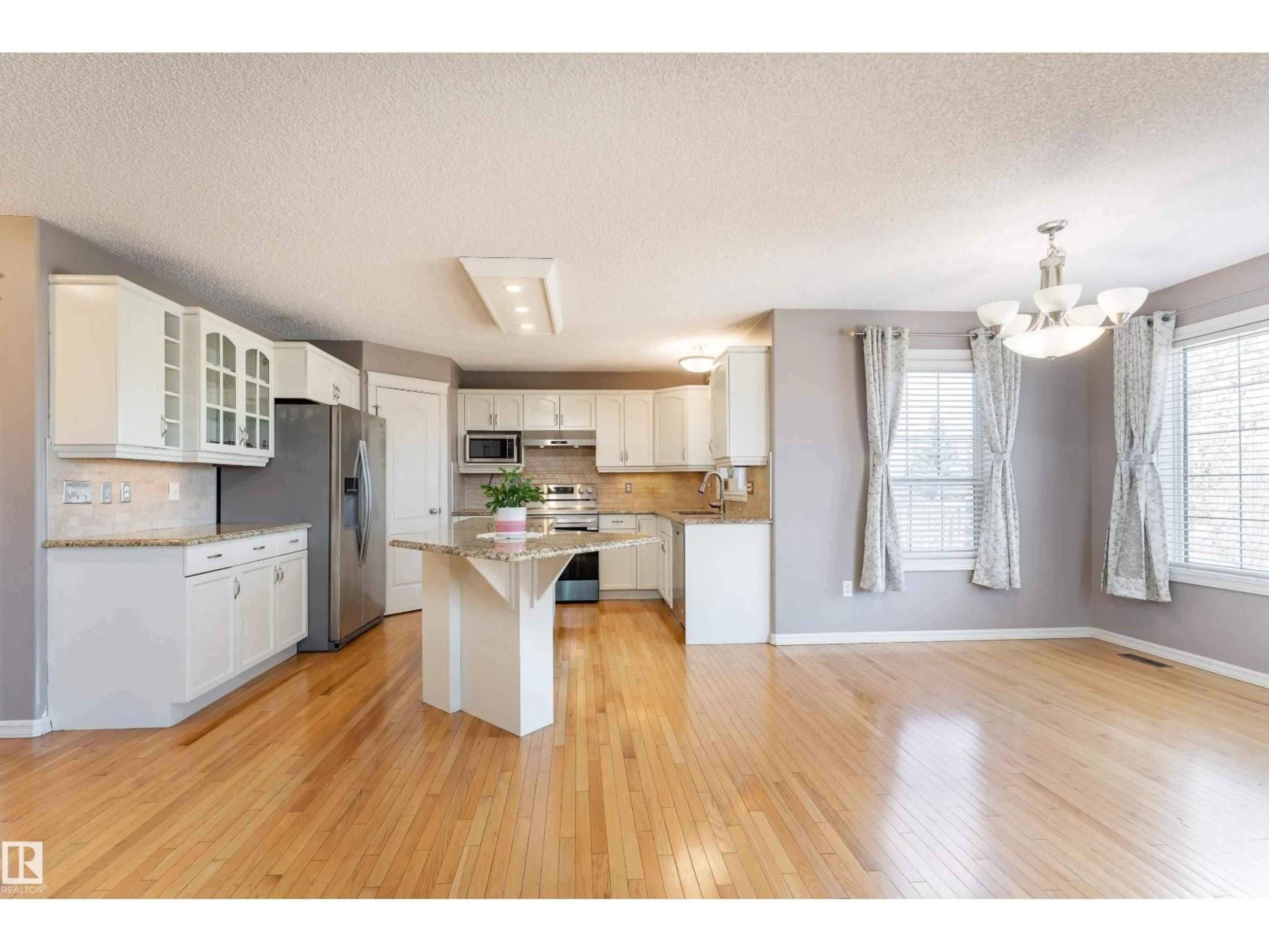Open concept kitchen, wood/laminate floor for 1044 BARNES WY, Edmonton Alberta T6W1E4