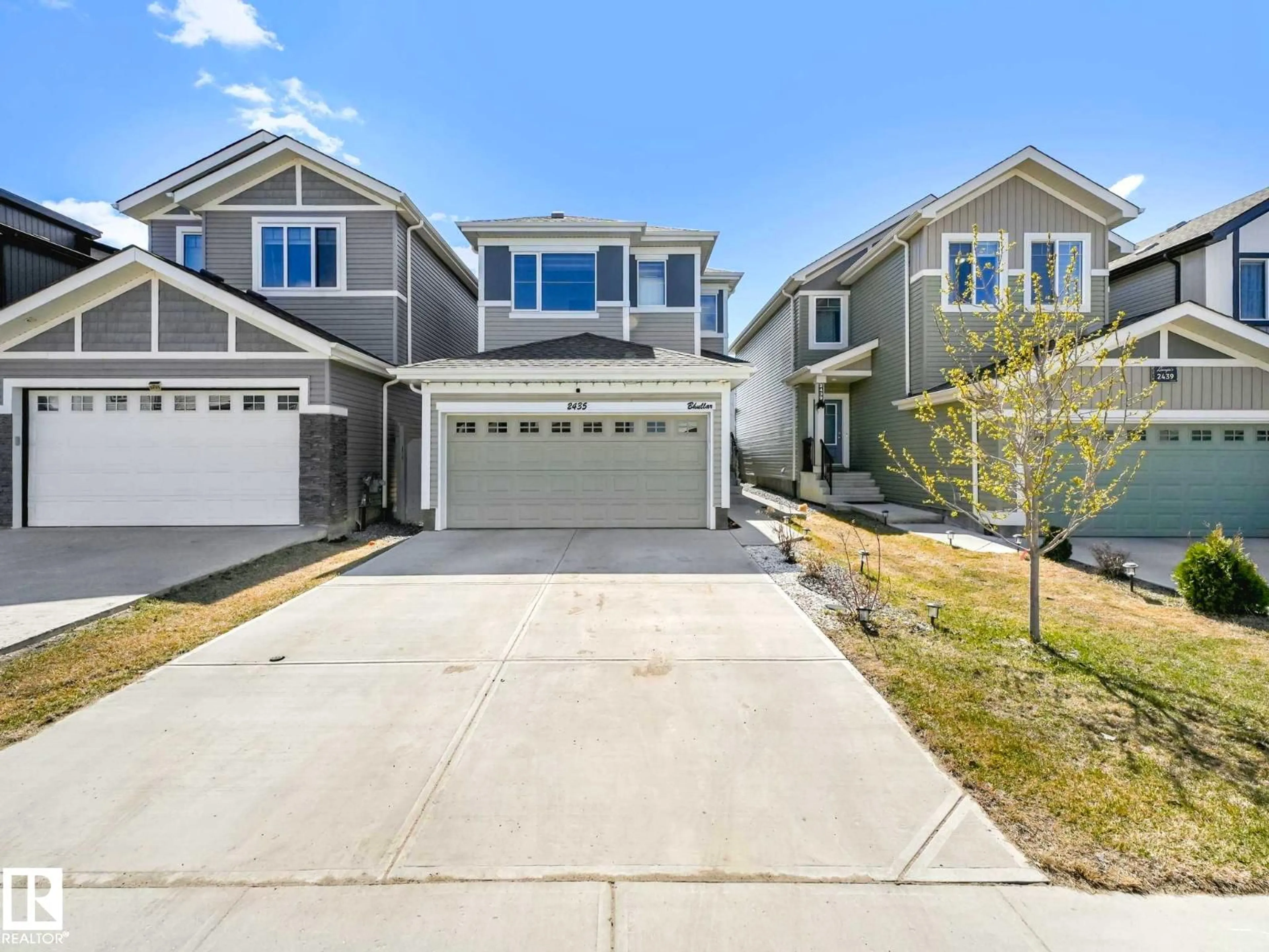 Home with vinyl exterior material, street for 2435 12 AV, Edmonton Alberta T6T2M6