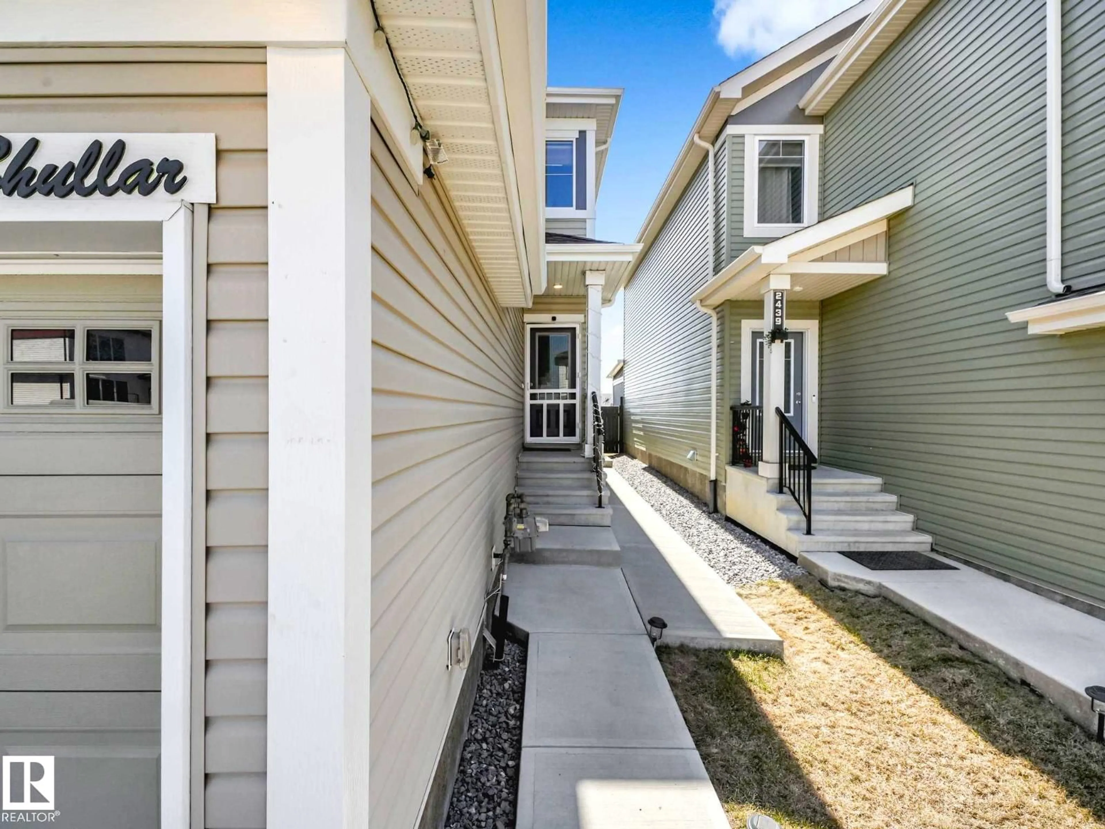 Home with vinyl exterior material, street for 2435 12 AV, Edmonton Alberta T6T2M6