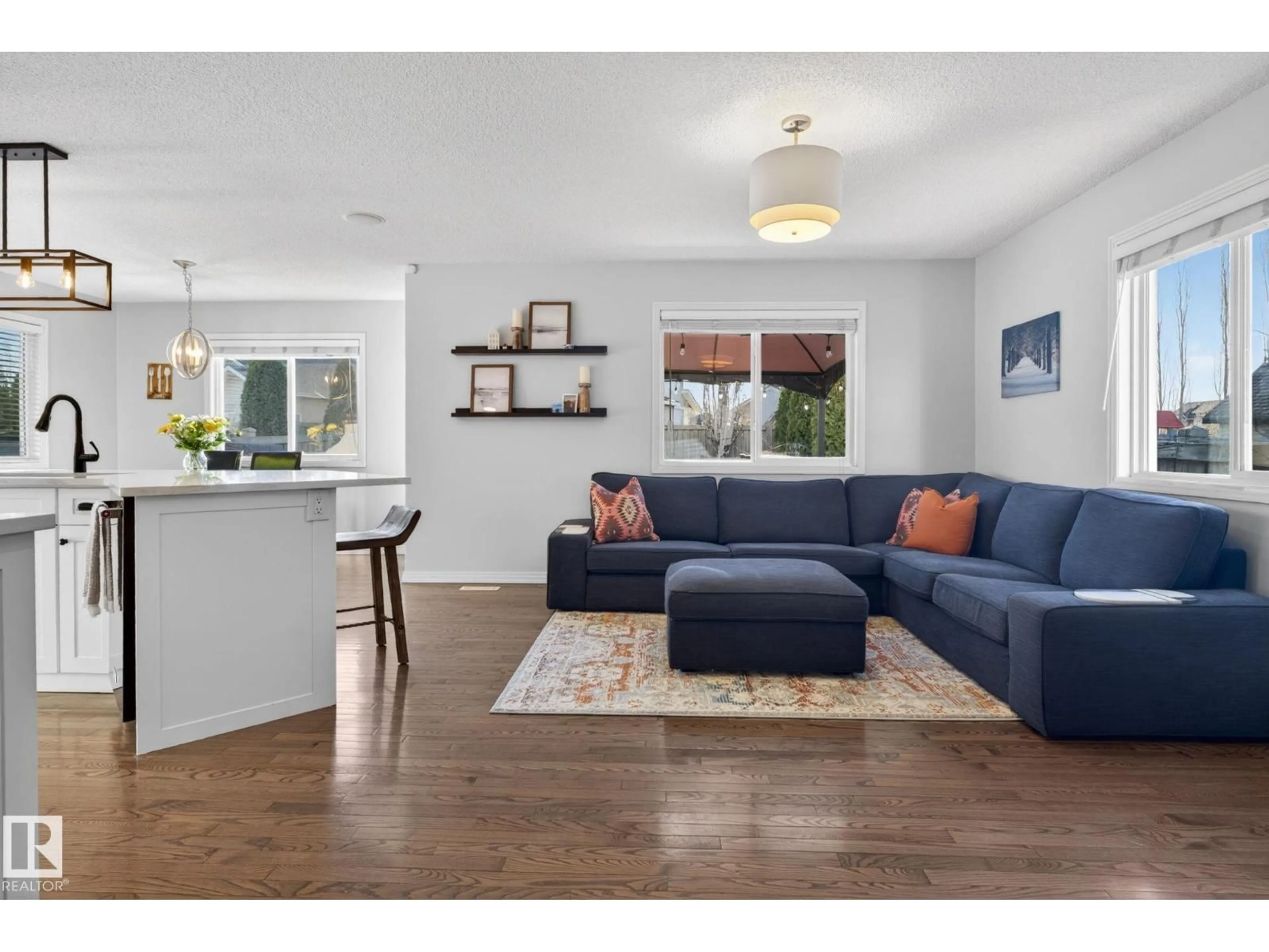 Living room with furniture, wood/laminate floor for NW - 5112 206 ST, Edmonton Alberta T6M0C5