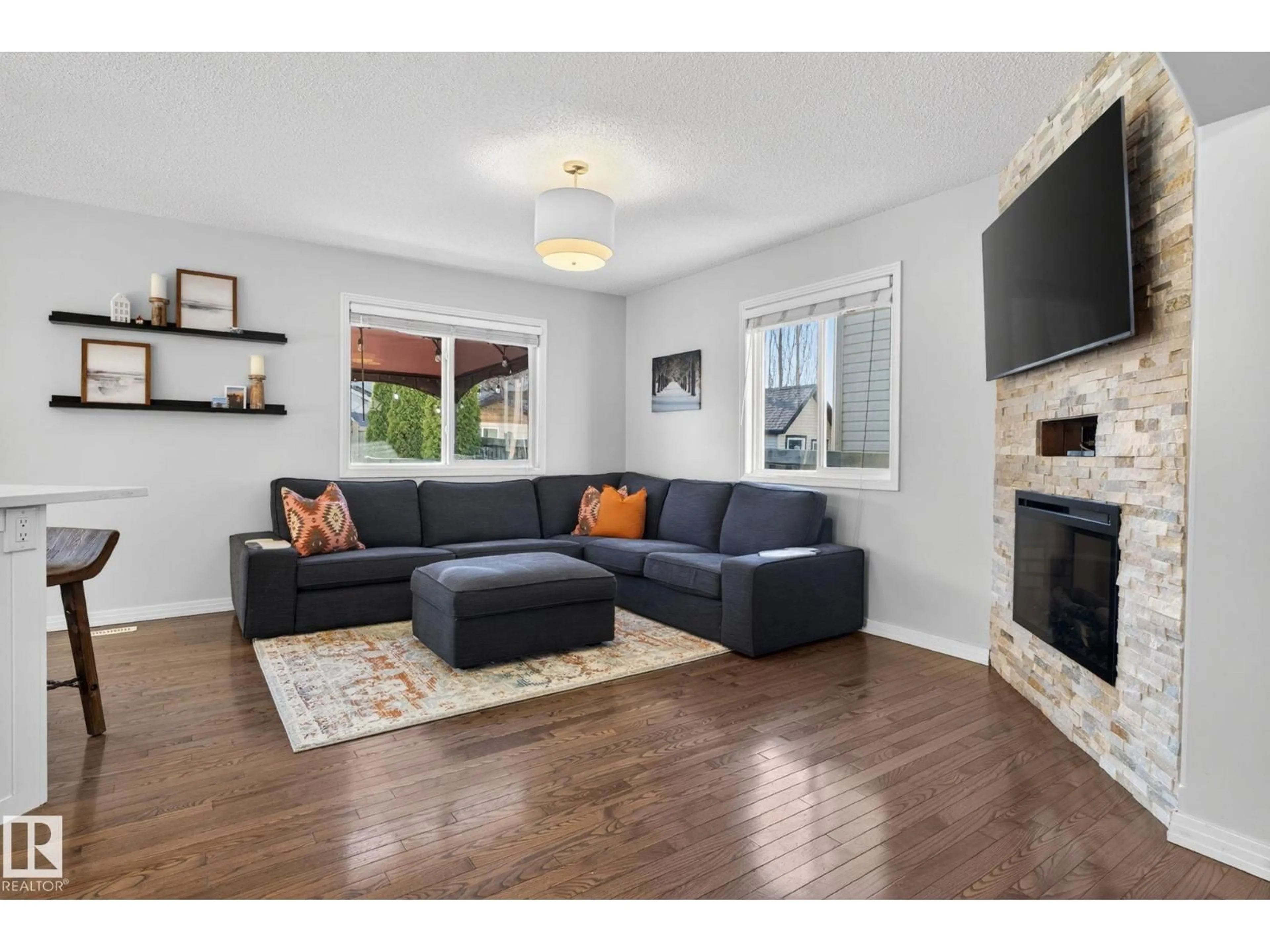 Living room with furniture, wood/laminate floor for NW - 5112 206 ST, Edmonton Alberta T6M0C5