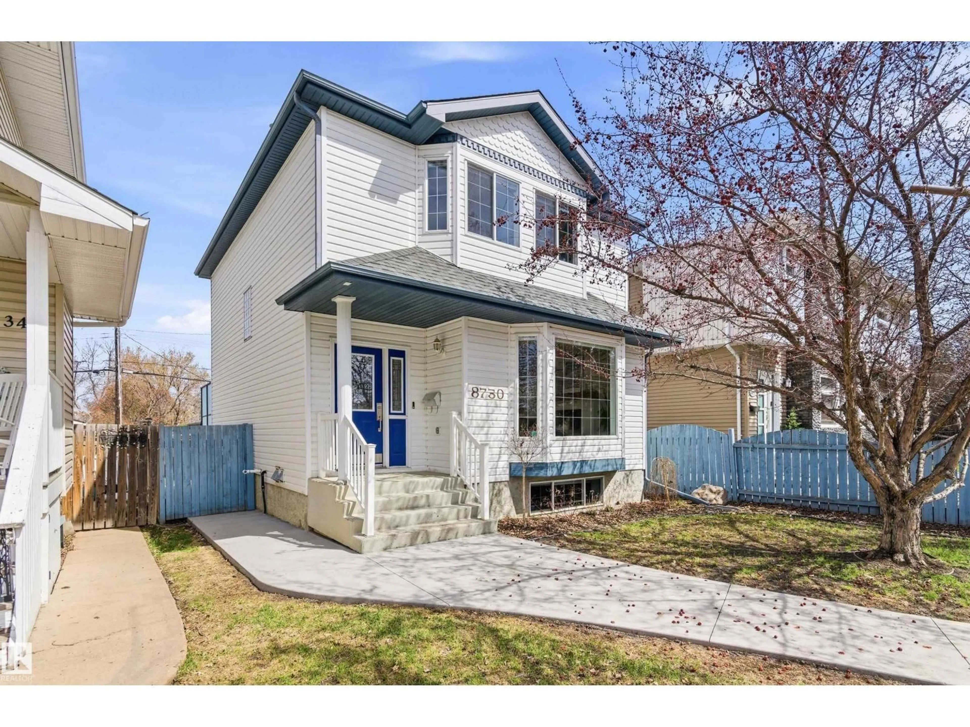 Home with vinyl exterior material, street for NW - 8730 92A AV, Edmonton Alberta T6C1S6