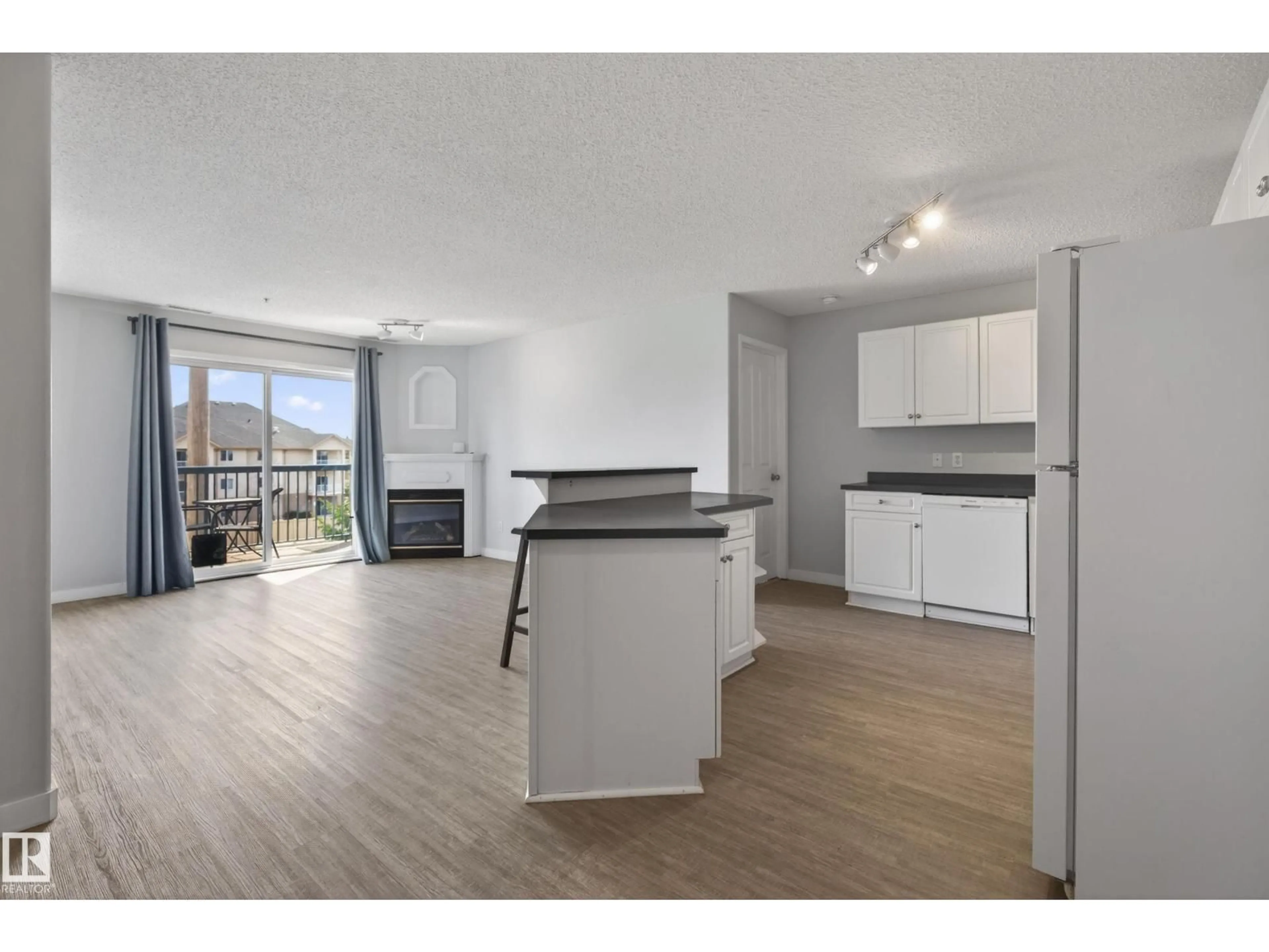 Open concept kitchen, wood/laminate floor for NW - 319 16303 95 ST, Edmonton Alberta T5Z3V1