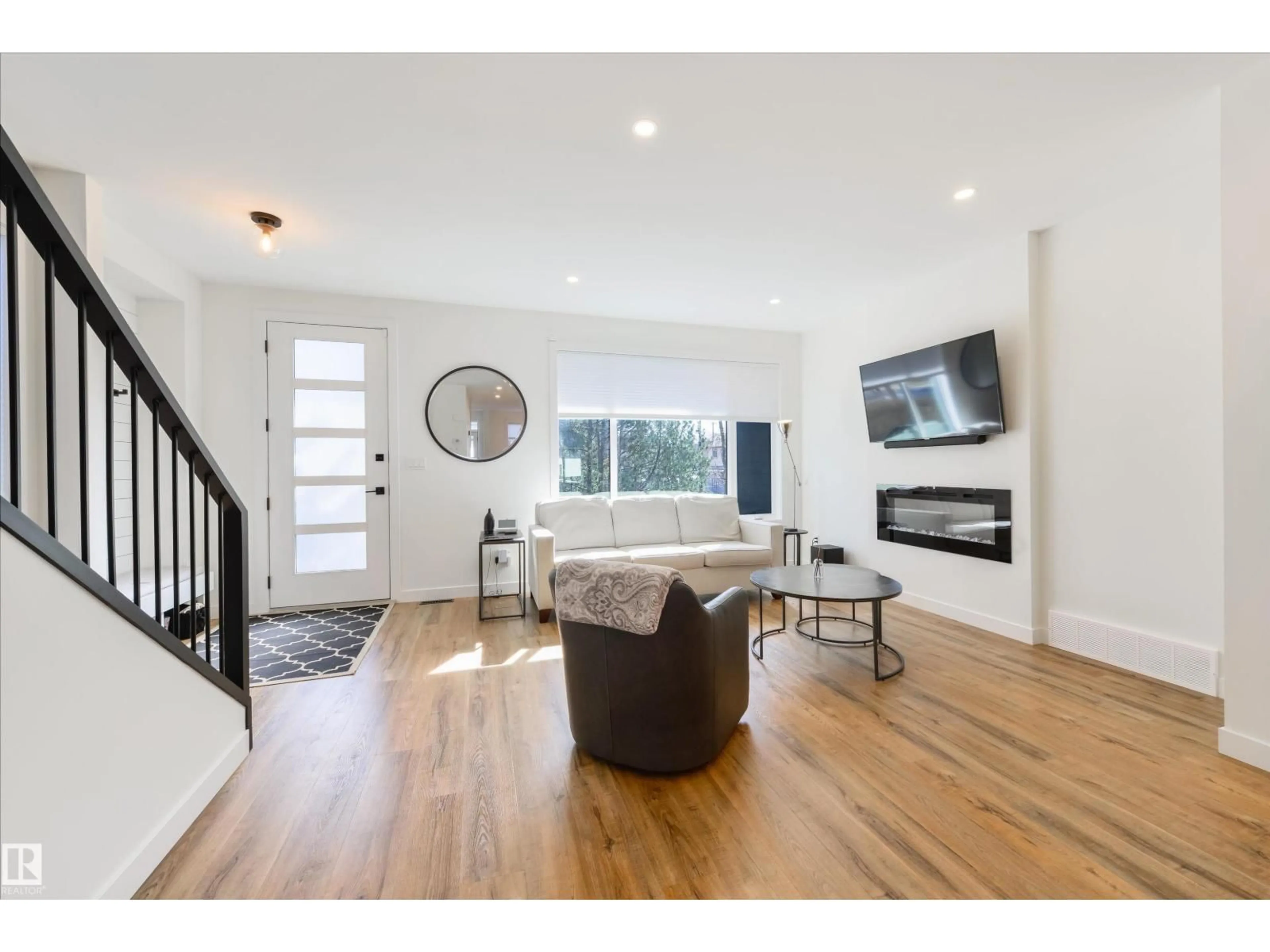 Living room with furniture, wood/laminate floor for NW - 11414 125 ST, Edmonton Alberta T5M0M9