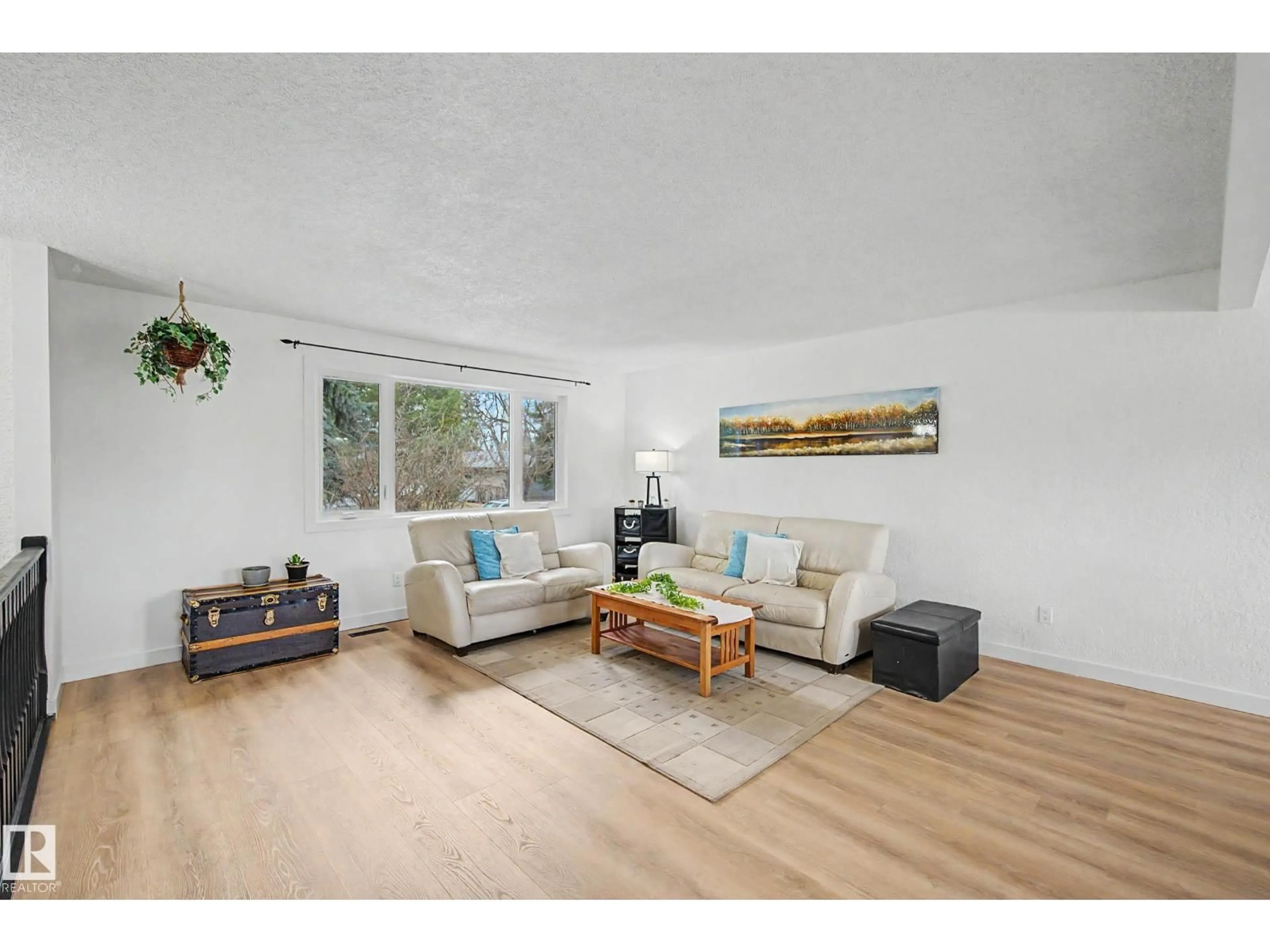 Living room with furniture, wood/laminate floor for 1945 GLENMORE AV, Sherwood Park Alberta T8A0X6