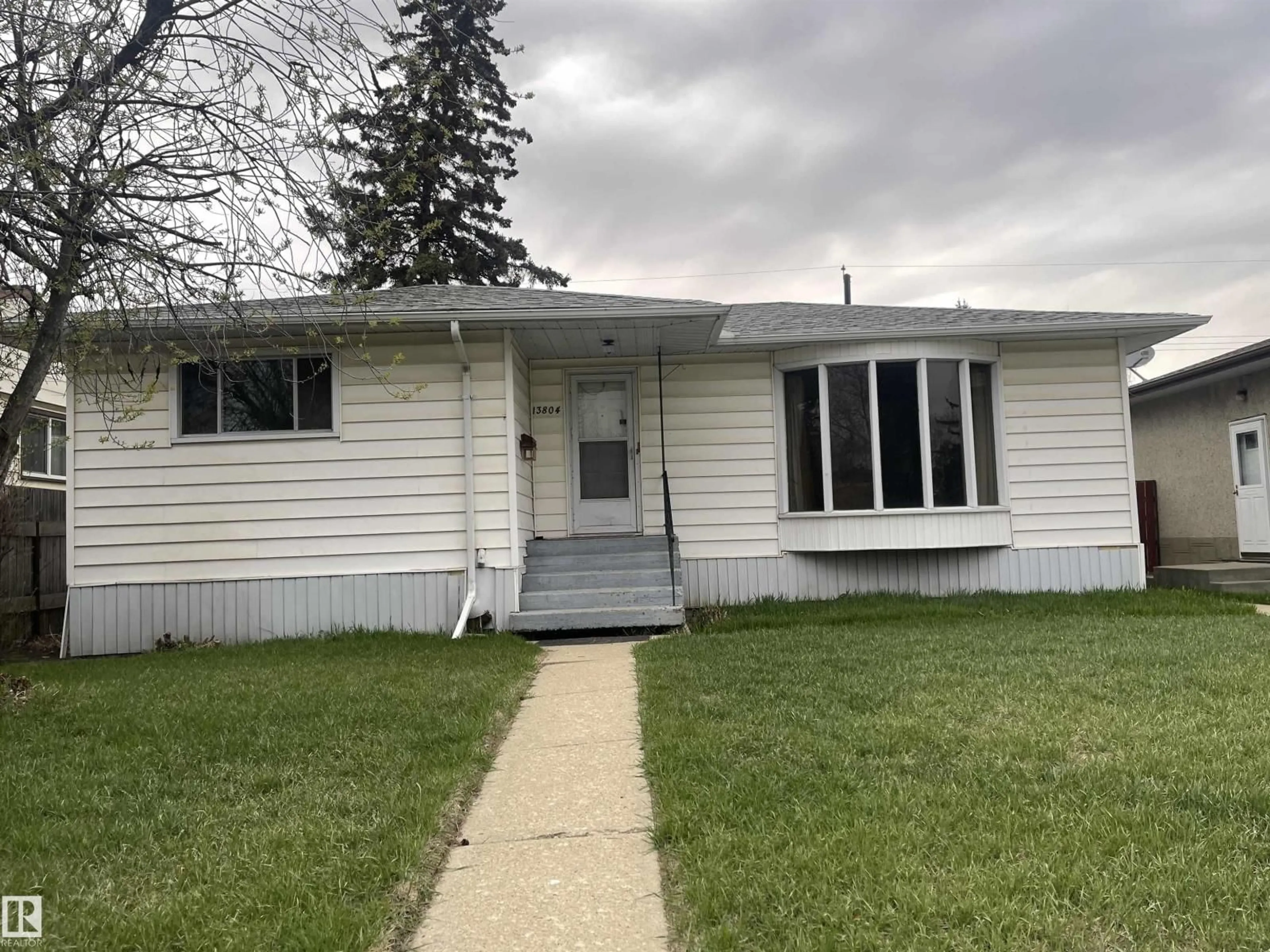 Home with vinyl exterior material, street for 13804 132 AV, Edmonton Alberta T5L3R8